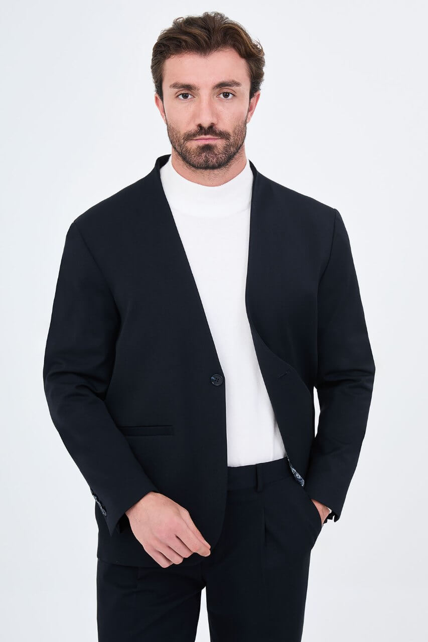 Men's navy blue slim-fit two-piece suit with a modern collarless V-neck jacket and matching trousers.