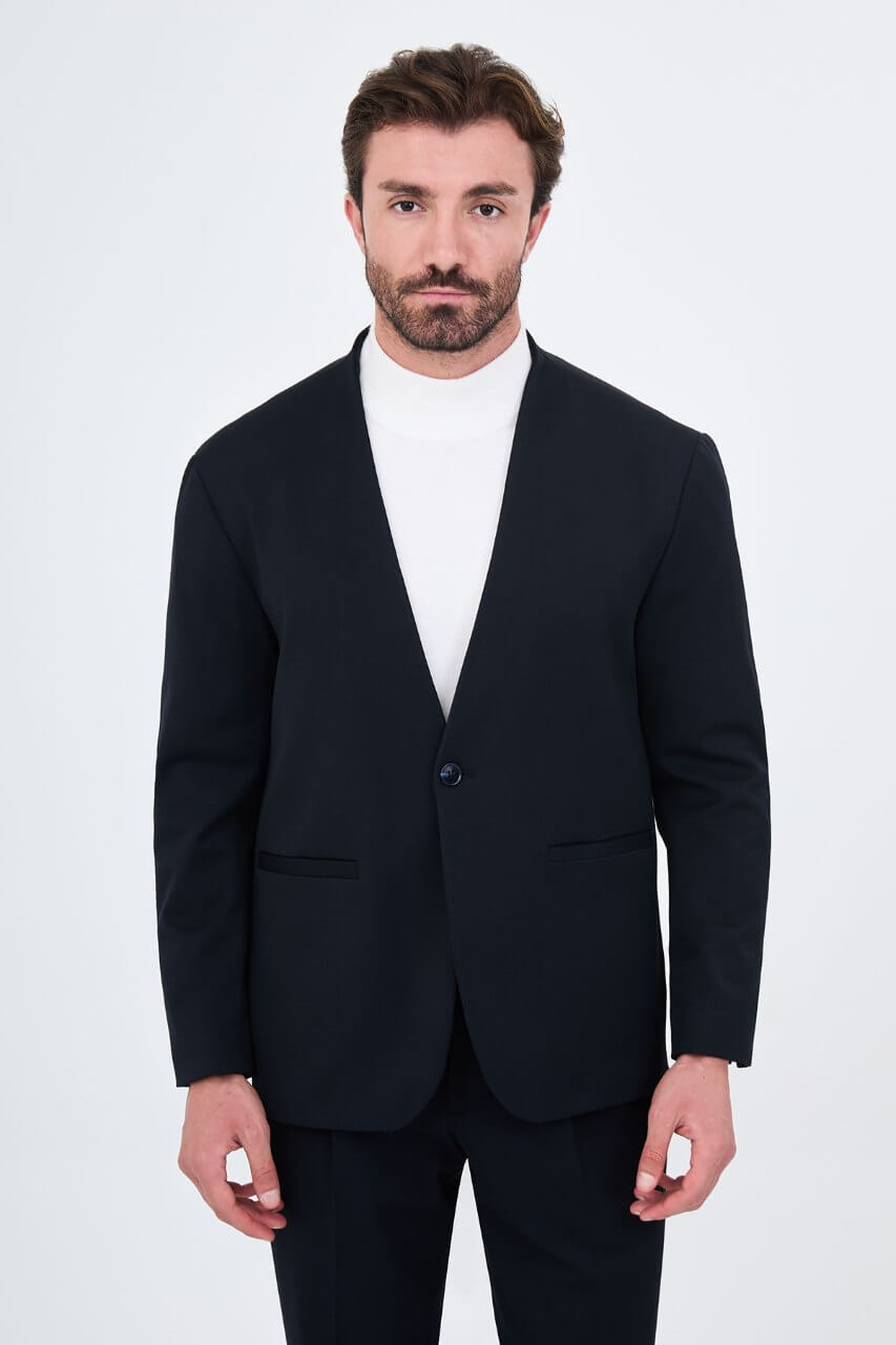 Men's navy blue slim-fit two-piece suit with a modern collarless V-neck jacket and matching trousers.