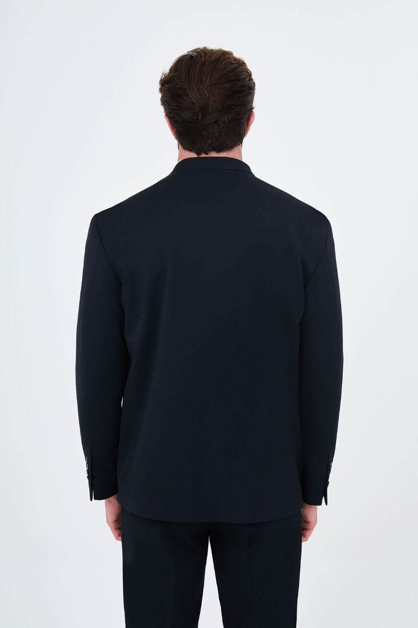 Men's navy blue slim-fit two-piece suit with a modern collarless V-neck jacket and matching trousers.