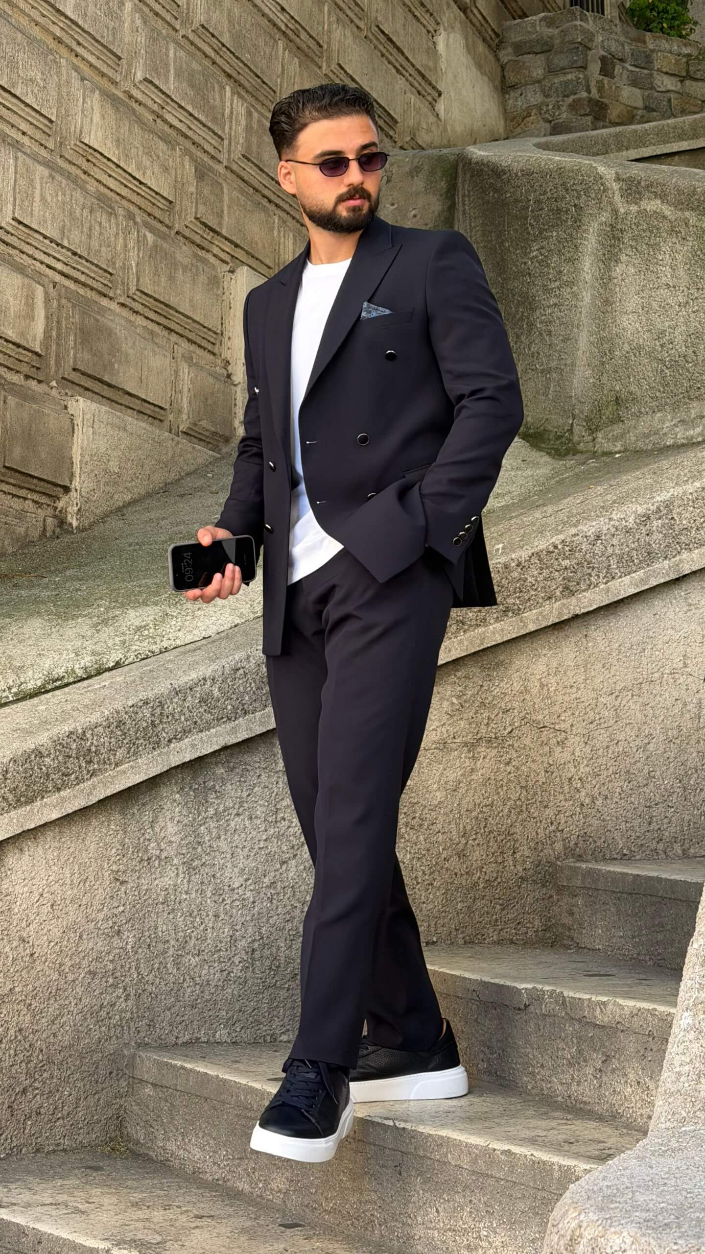 Men’s navy blue double breasted suit with peak lapels, tailored jacket, matching trousers, and modern formal style for weddings and business occasions.