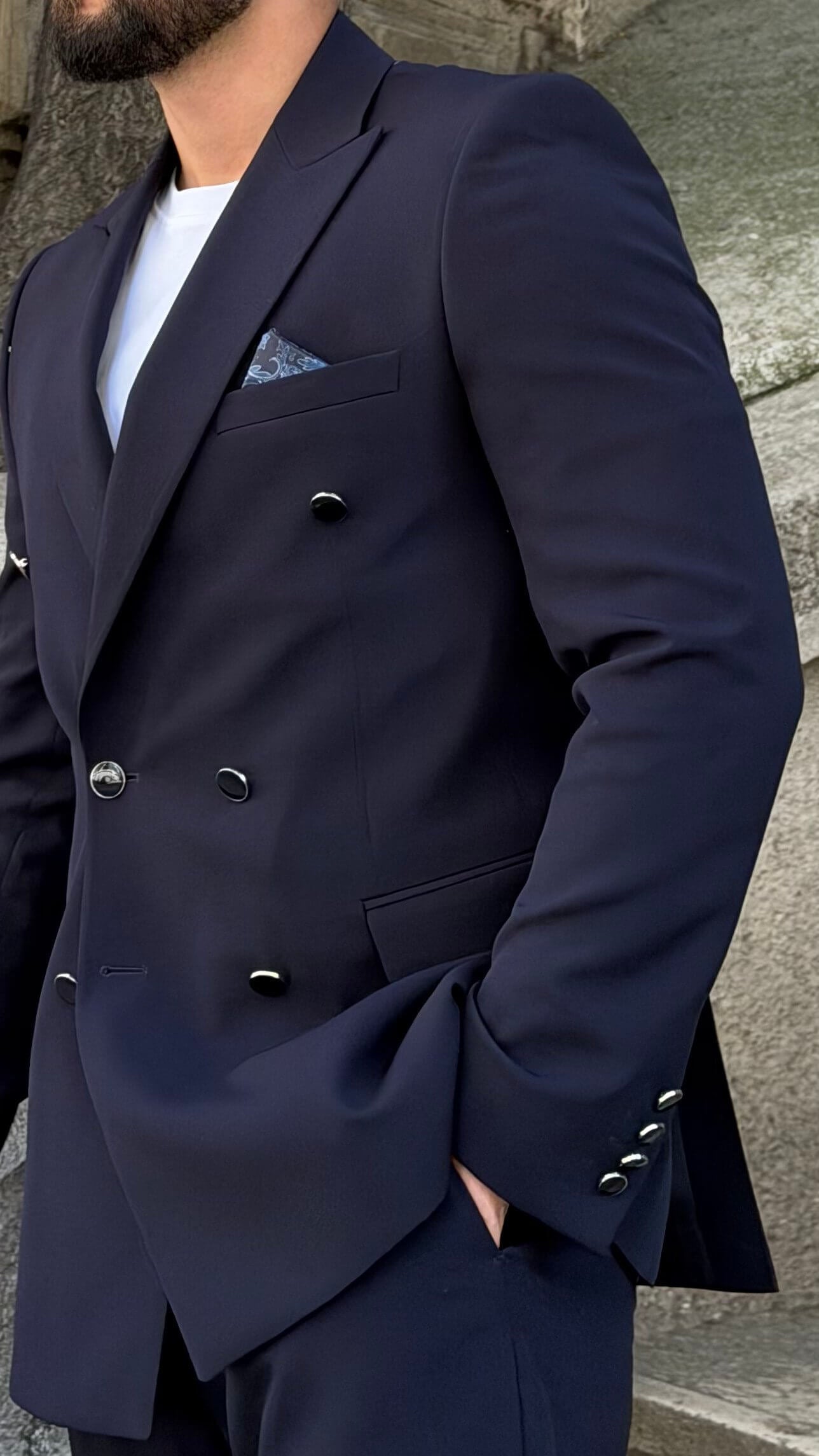 Men’s navy blue double breasted suit with peak lapels, tailored jacket, matching trousers, and modern formal style for weddings and business occasions.