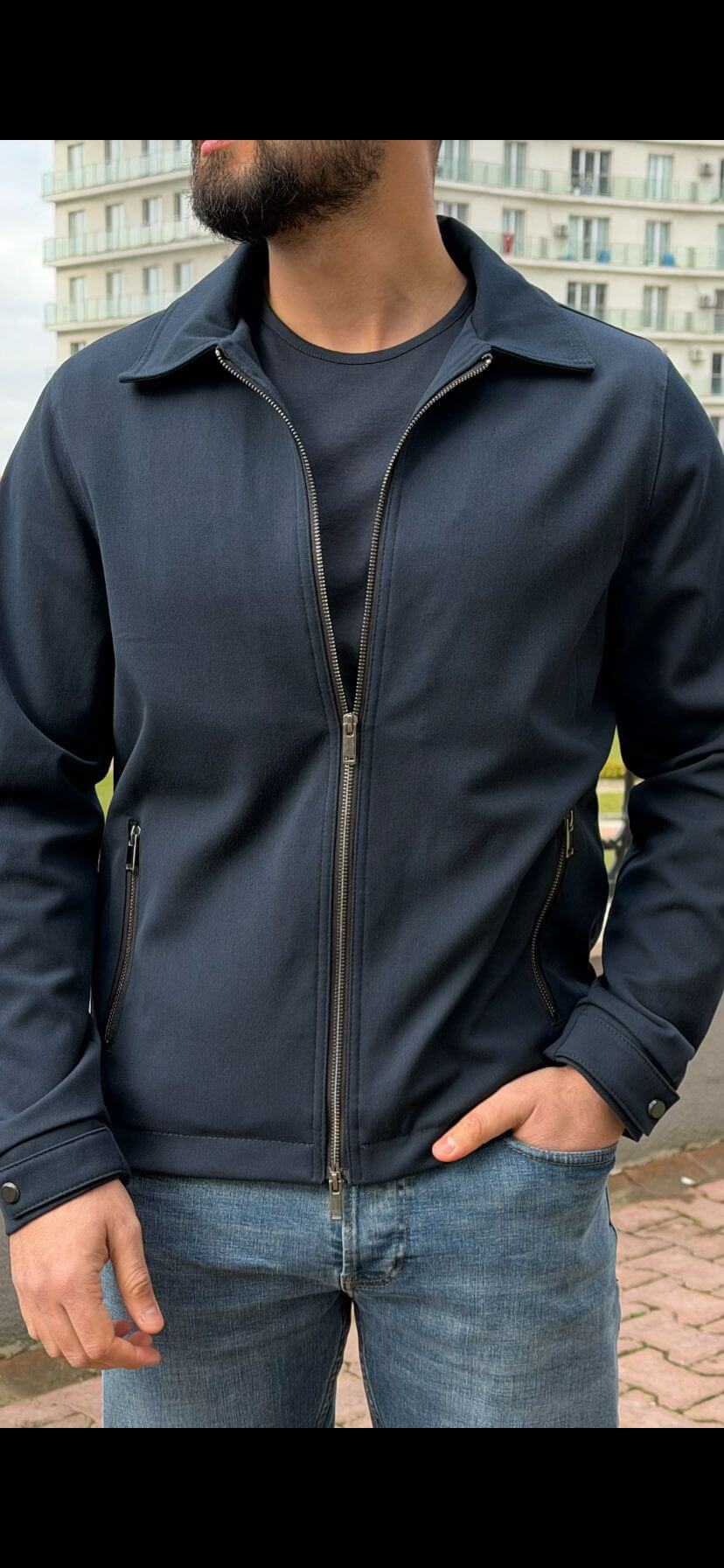 Men’s navy blue zip-up jacket with tailored fit and minimalist design, smart casual outerwear styled with denim jeans