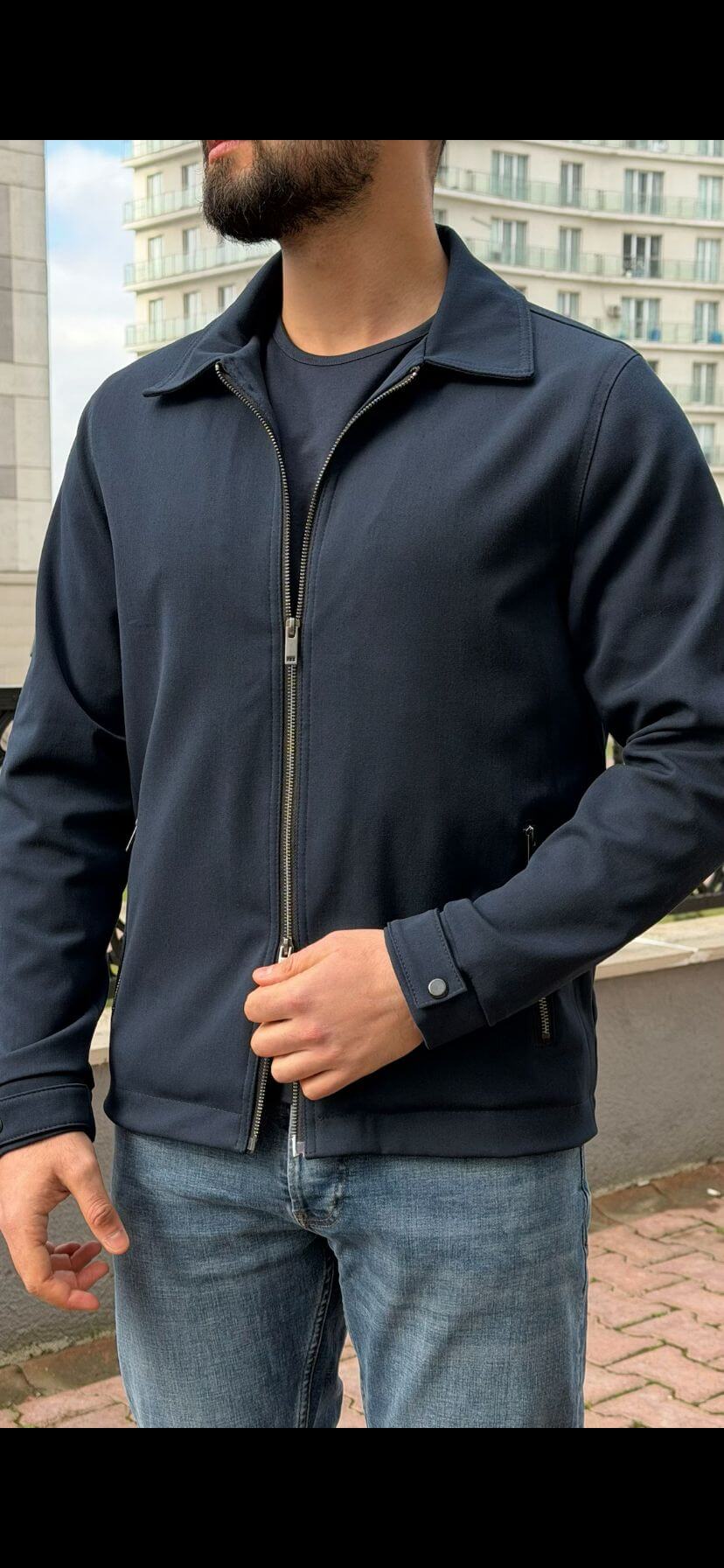 Men’s navy blue zip-up jacket with tailored fit and minimalist design, smart casual outerwear styled with denim jeans