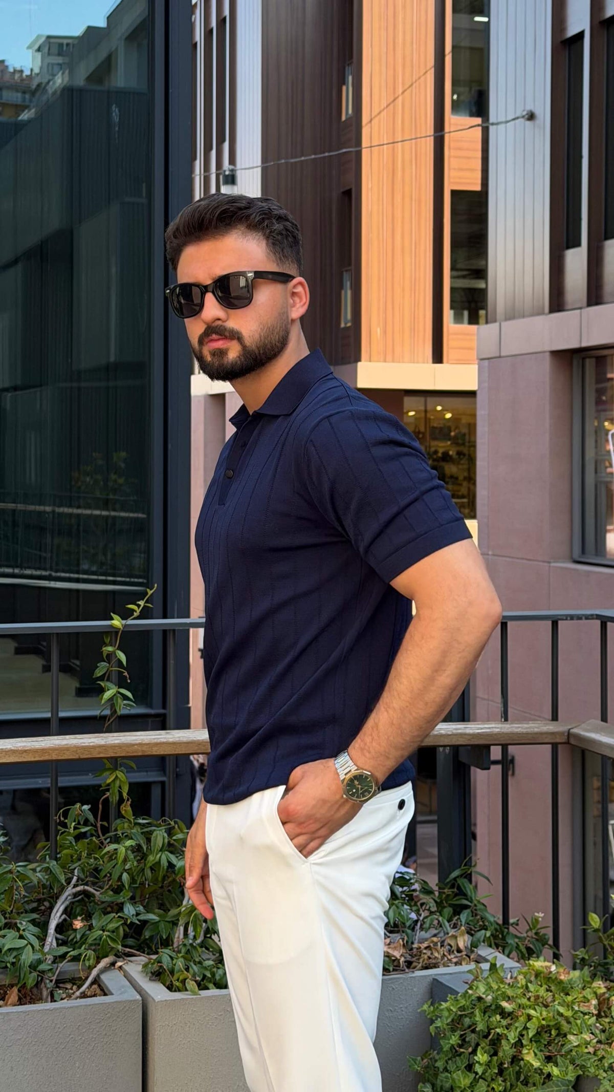 Men’s navy blue knitted polo shirt with textured fabric and smart casual style