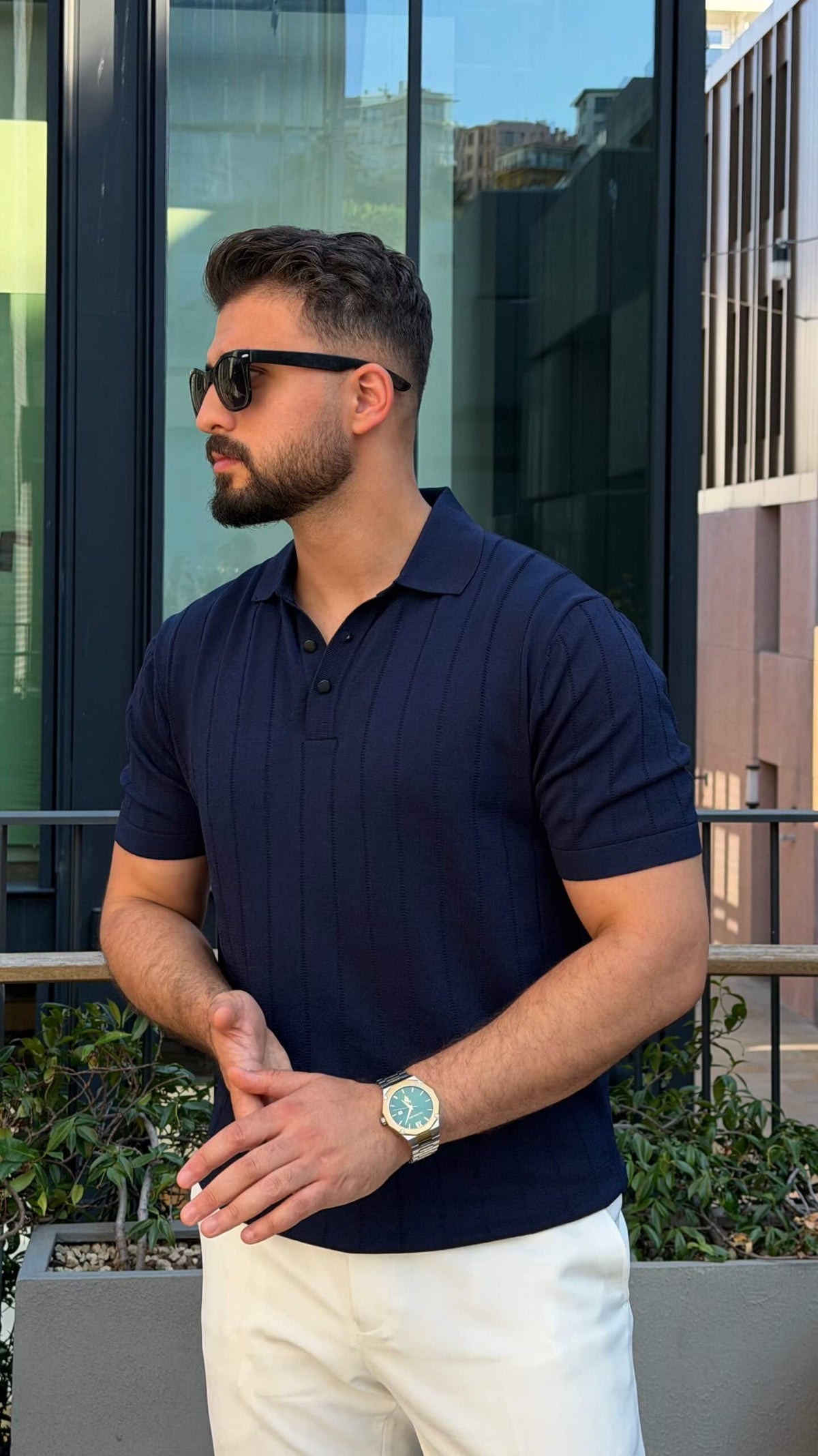Men’s navy blue knitted polo shirt with textured fabric and smart casual style