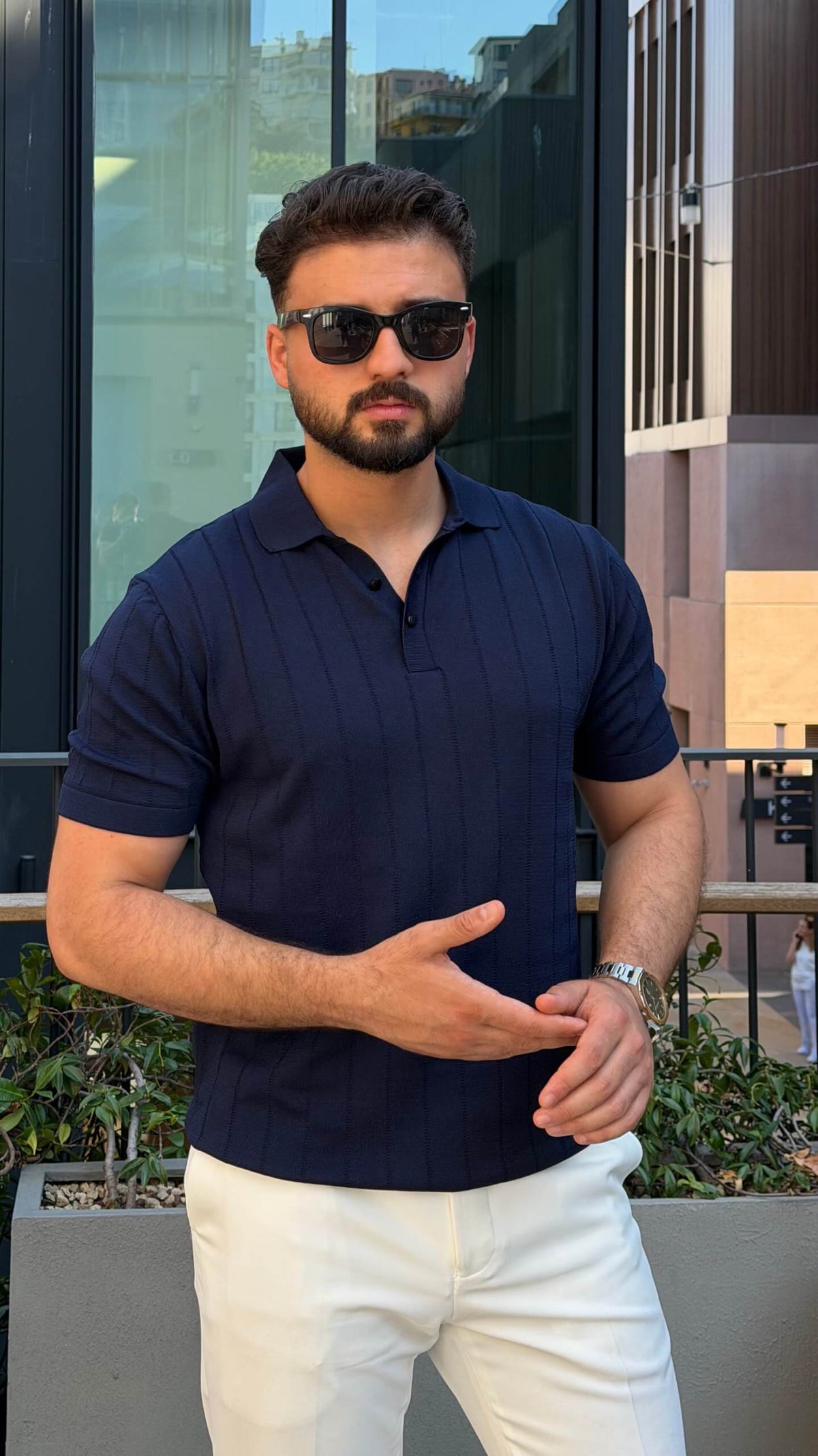 Men’s navy blue knitted polo shirt with textured fabric and smart casual style
