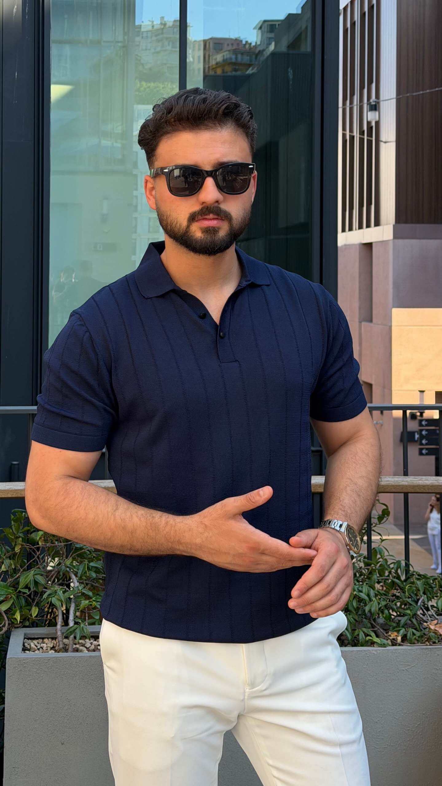 Men’s navy blue knitted polo shirt with textured fabric and smart casual style