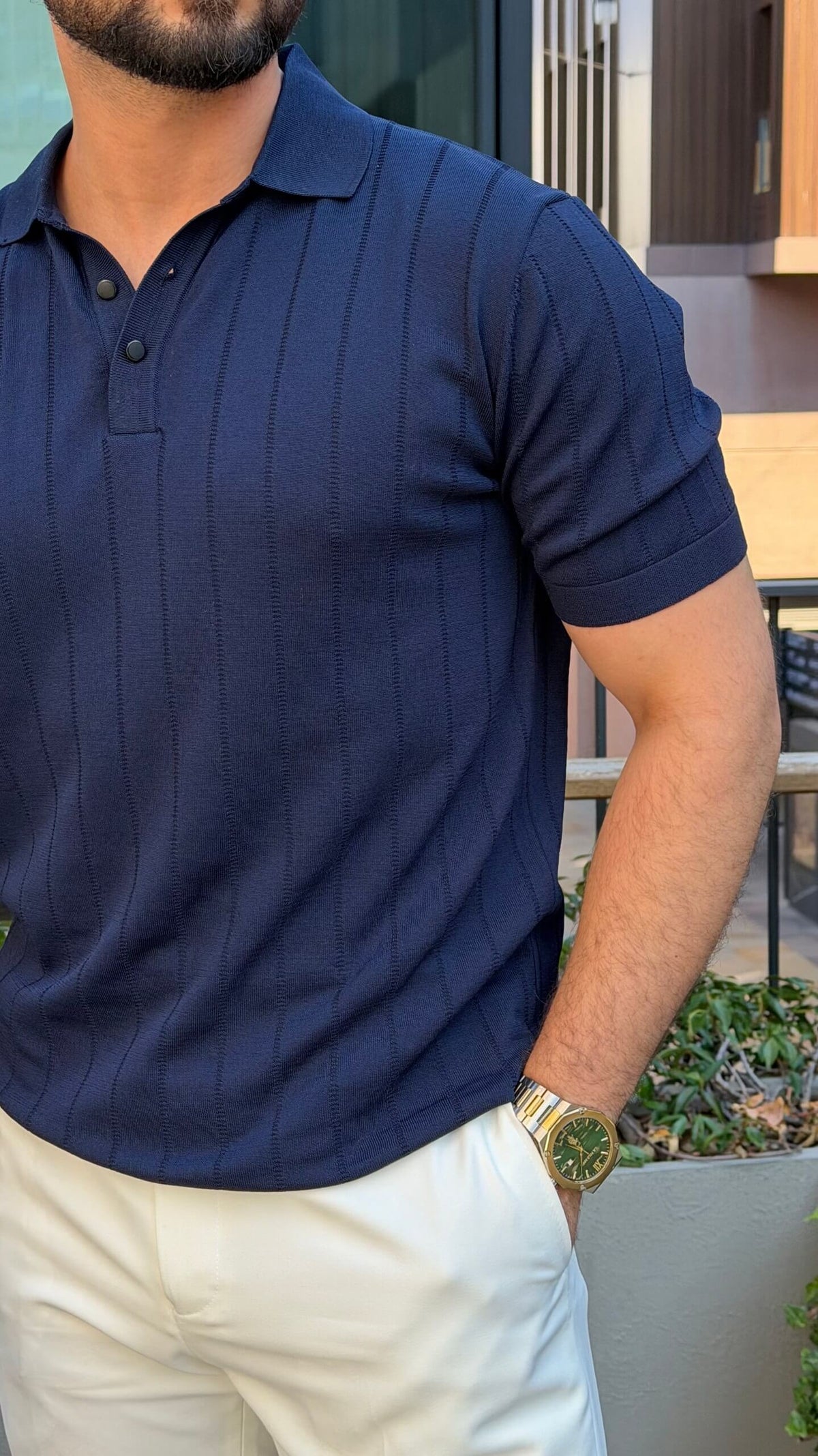 Men’s navy blue knitted polo shirt with textured fabric and smart casual style