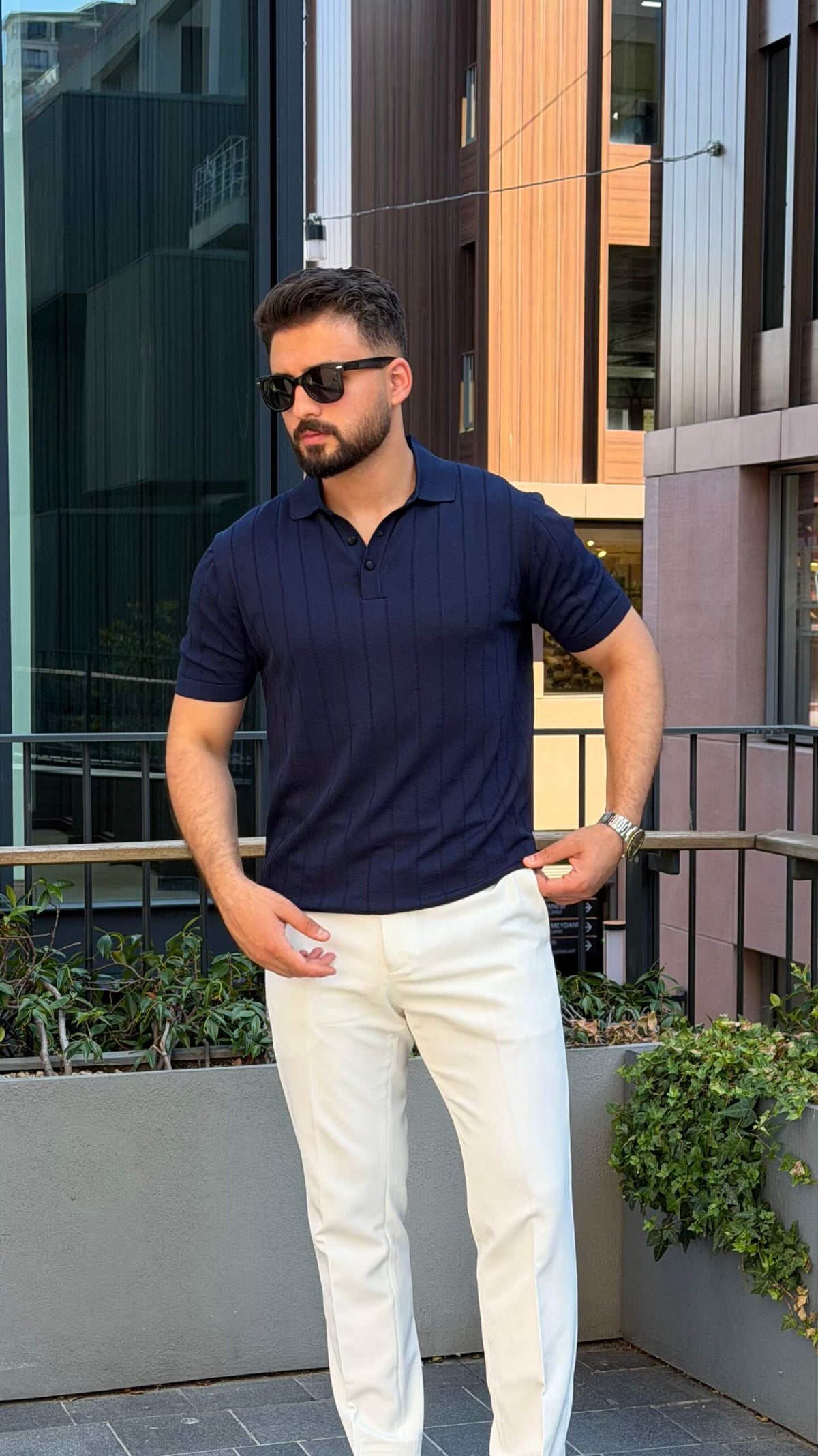 Men’s navy blue knitted polo shirt with textured fabric and smart casual style