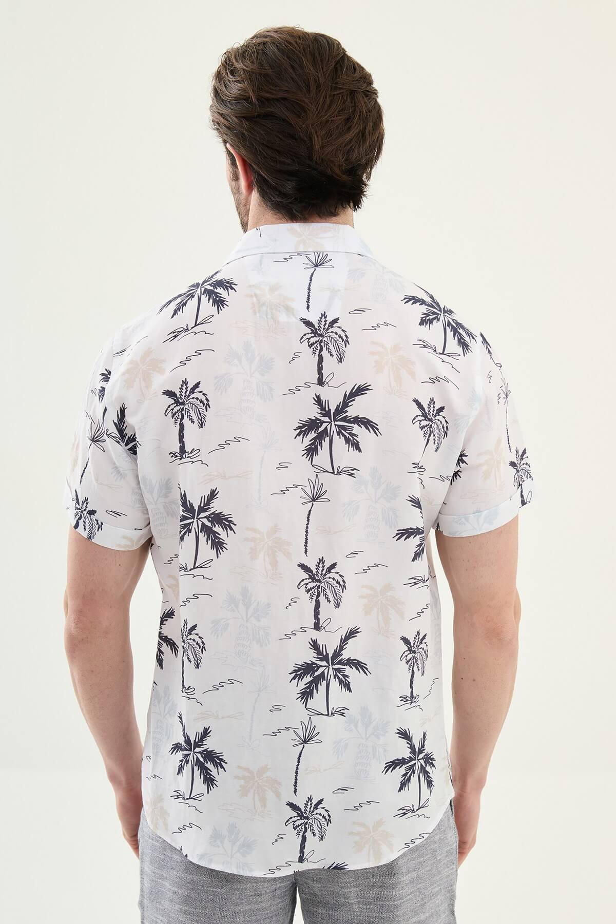 Men’s navy blue palm tree print short sleeve shirt in a lightweight Tencel and linen blend with a relaxed summer resort style.