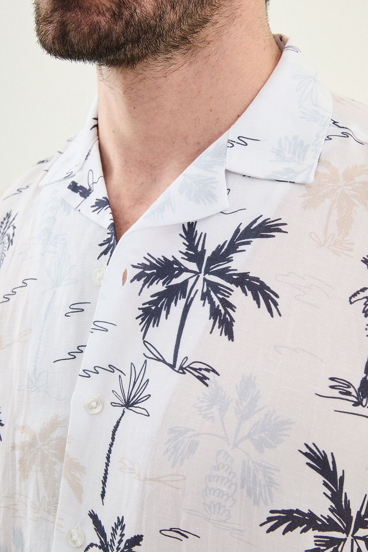 Men’s navy blue palm tree print short sleeve shirt in a lightweight Tencel and linen blend with a relaxed summer resort style.