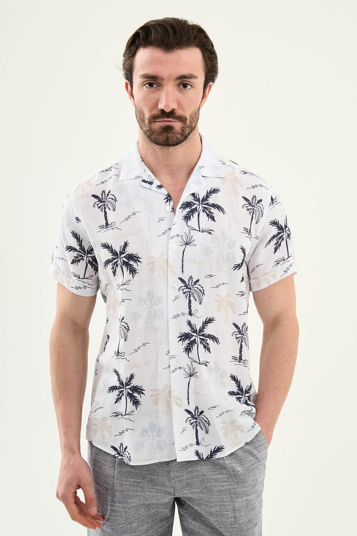 Men’s navy blue palm tree print short sleeve shirt in a lightweight Tencel and linen blend with a relaxed summer resort style.