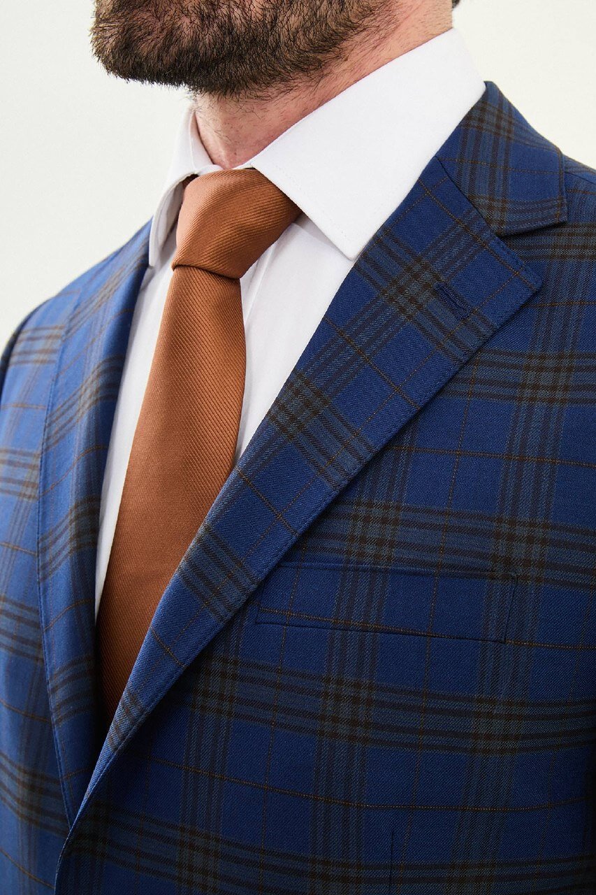Men wearing navy blue plaid slim fit suit with two-button jacket and flat-front trousers, styled for business and formal events