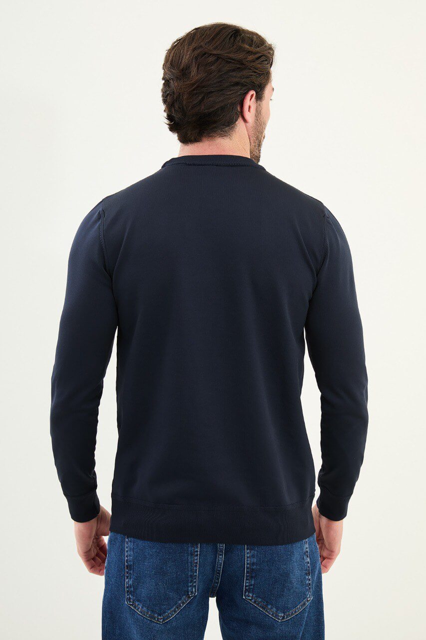 Men’s slim-fit navy blue crew-neck sweater with geometric ‘T’ textured knit front panel, cotton-viscose-elastane blend, styled with blue denim for winter smart-casual.