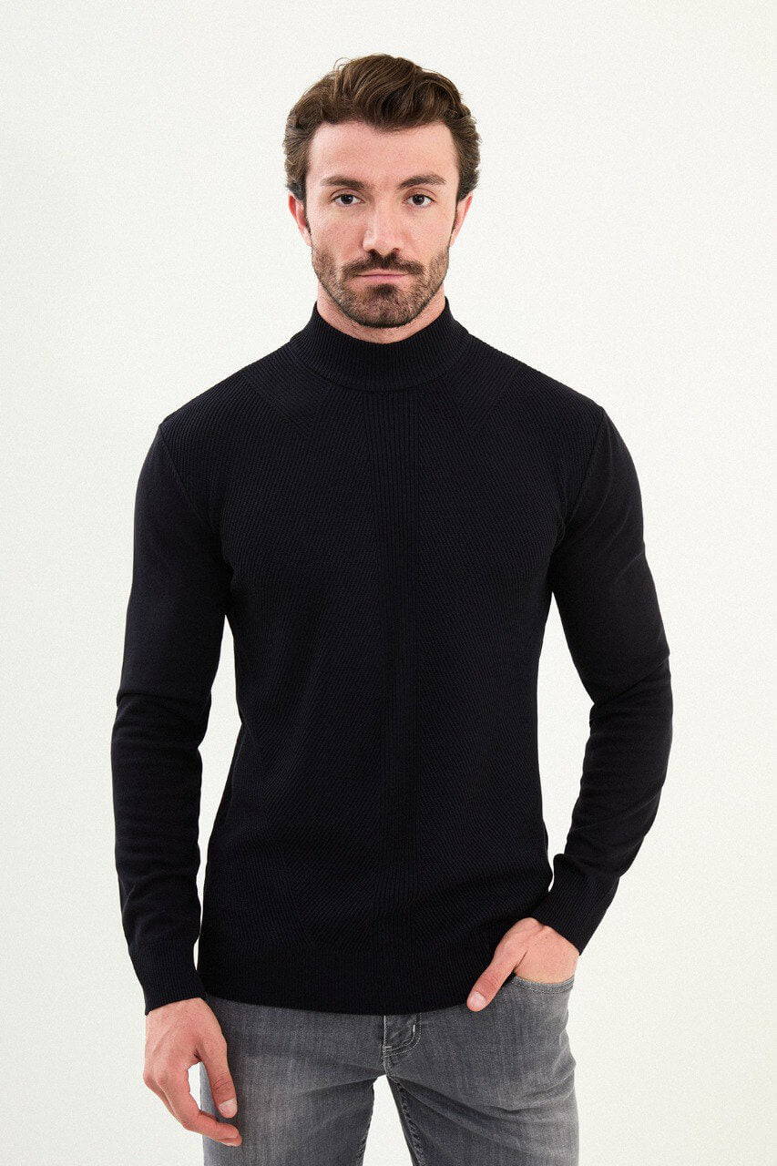 Men’s navy blue slim-fit ribbed mock-neck cotton-blend sweater with multi-directional ribbing and diagonal chest panels, styled with light gray denim.