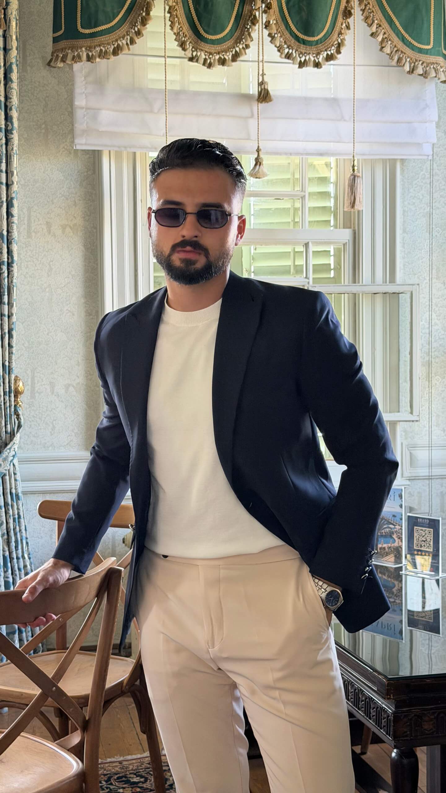Men's navy blue slim fit blazer styled with white trousers