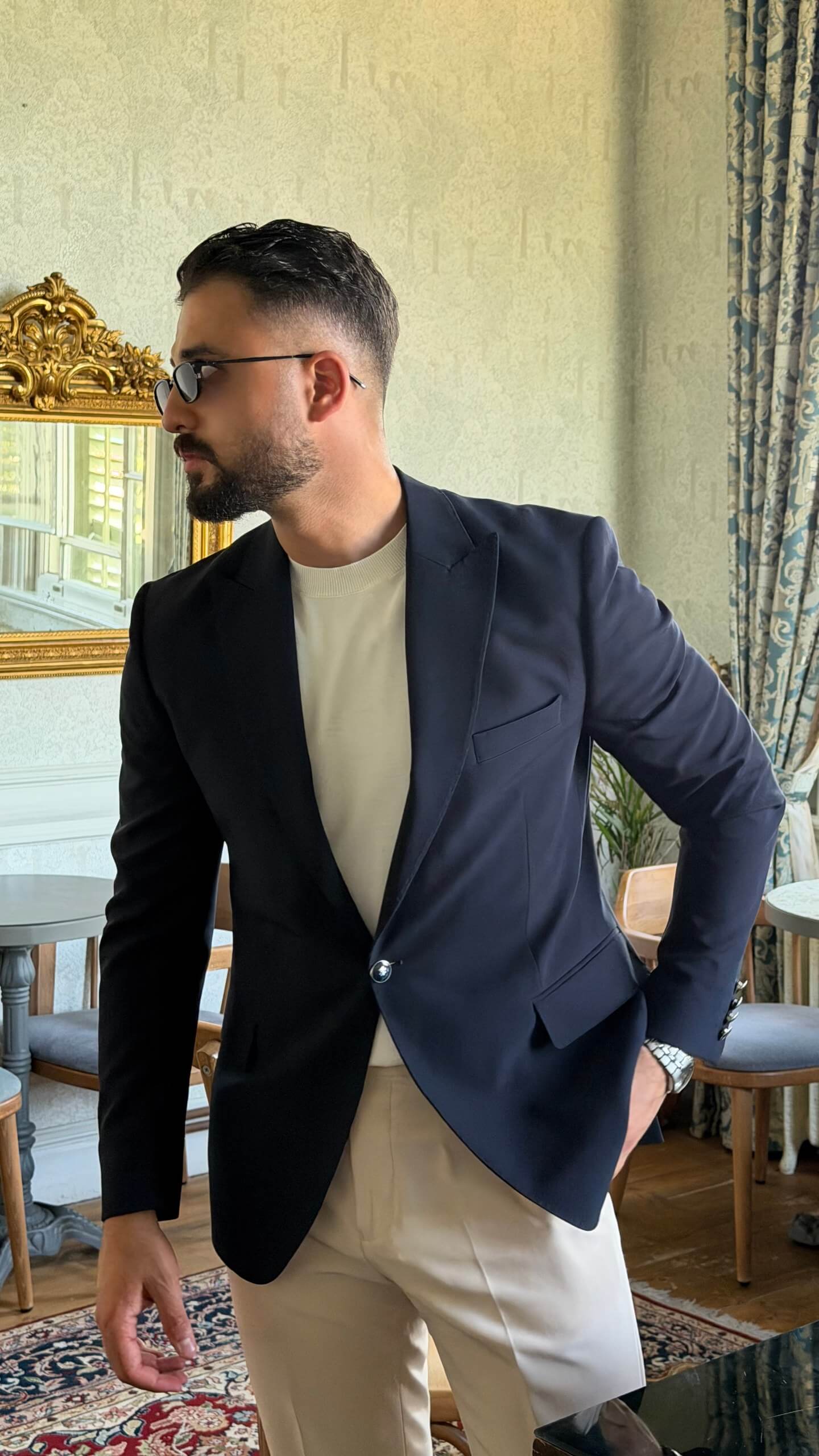 Men's navy blue slim fit blazer styled with white trousers