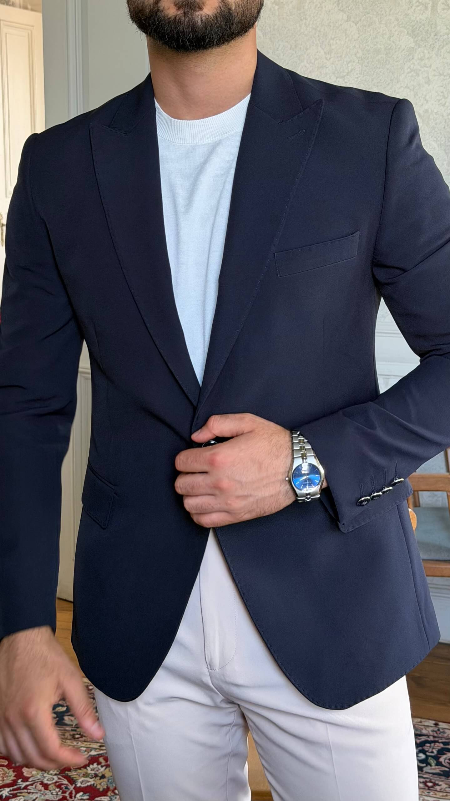 Men's navy blue slim fit blazer styled with white trousers