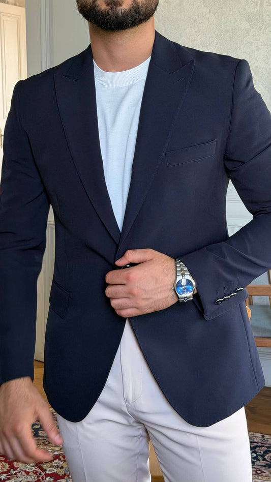Men's navy blue slim fit blazer styled with white trousers