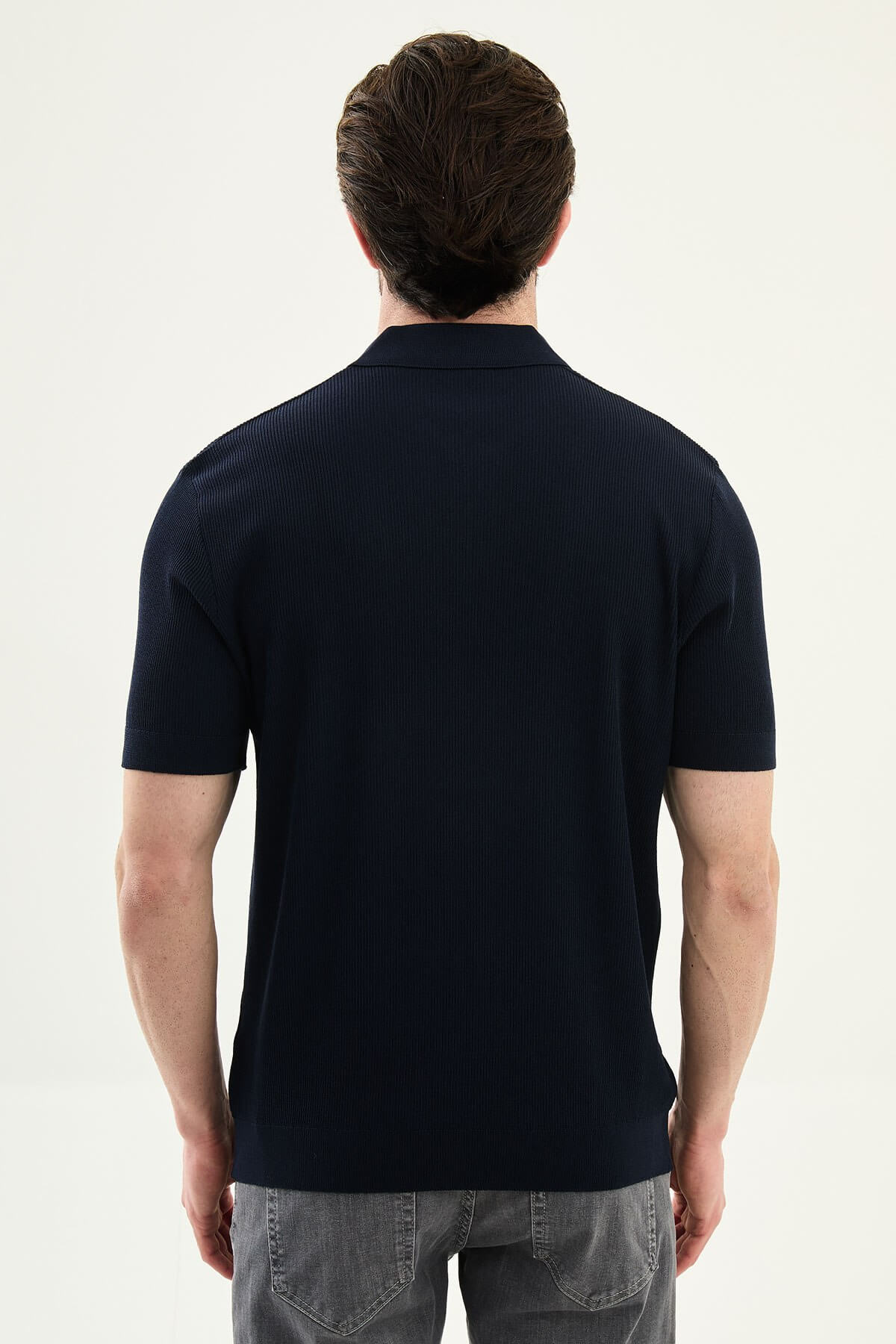 Men’s navy blue slim-fit knit polo shirt with classic collar, short sleeves, and textured knit finish for summer smart-casual style.