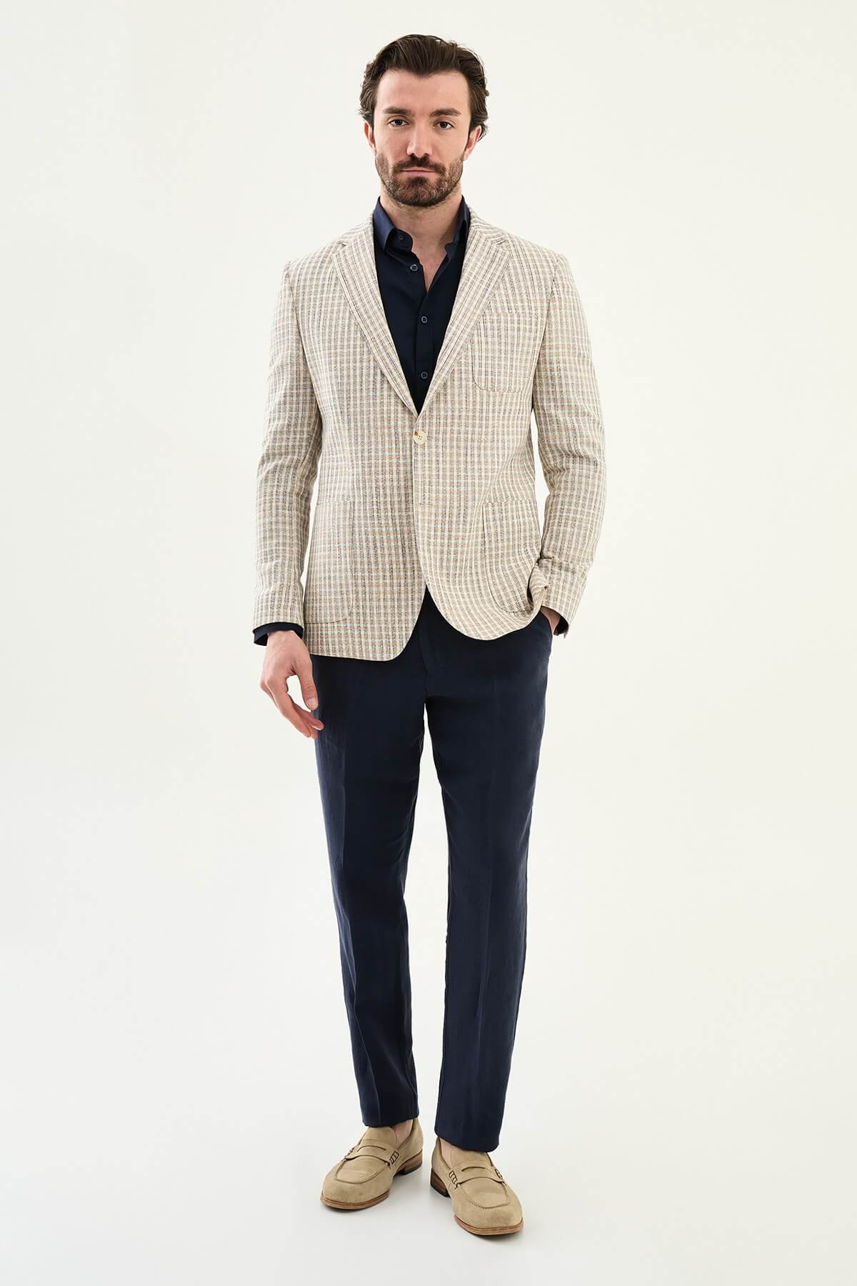 Men’s navy blue slim fit cotton linen blazer with a lightweight textured pattern, styled for elegant smart casual and summer occasions.
