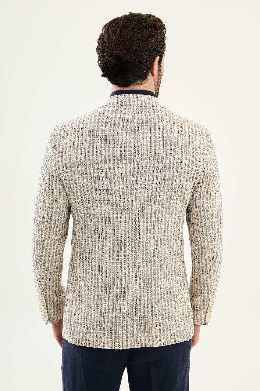 Men’s navy blue slim fit cotton linen blazer with a lightweight textured pattern, styled for elegant smart casual and summer occasions.