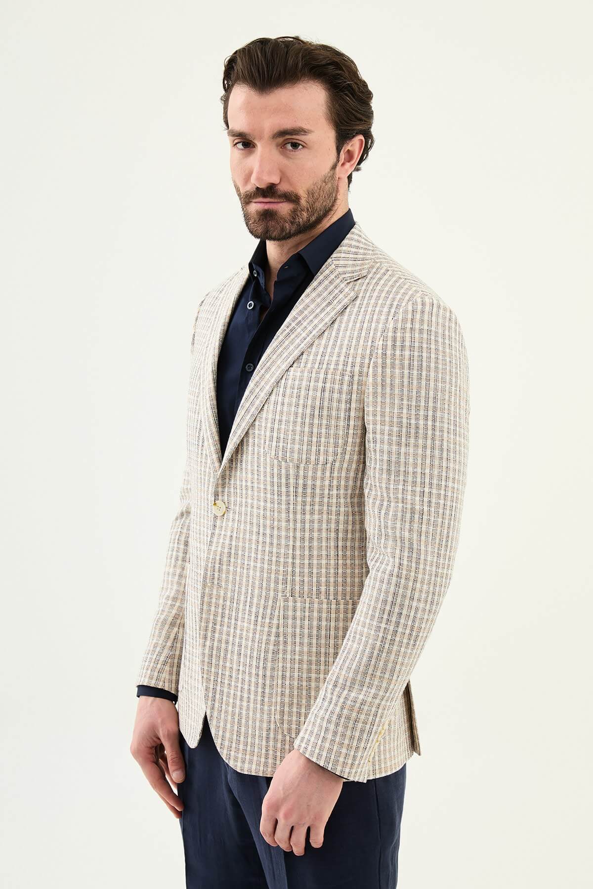 Men’s navy blue slim fit cotton linen blazer with a lightweight textured pattern, styled for elegant smart casual and summer occasions.