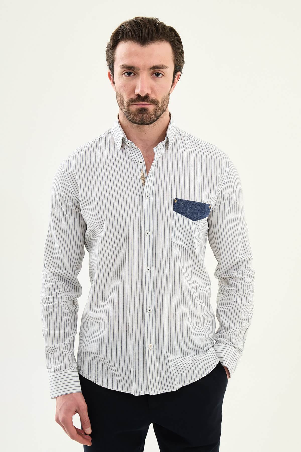 Men wearing a navy blue slim-fit long sleeve shirt with contrast pocket, styled in casual smart summer outfit.