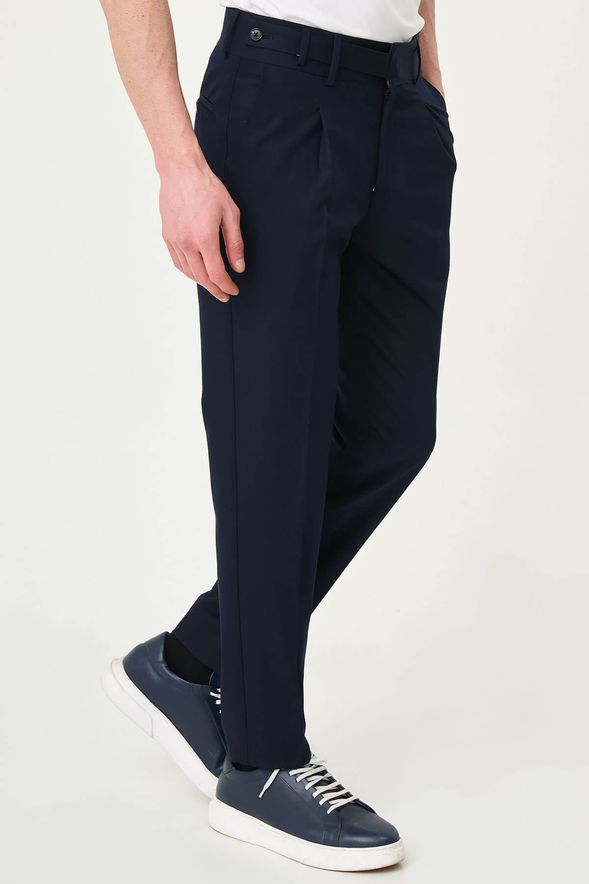 Navy Blue slim-fit straight-leg pleated trousers for men, styled with dark bluw sneakers, ideal for summer business and formal occasions.