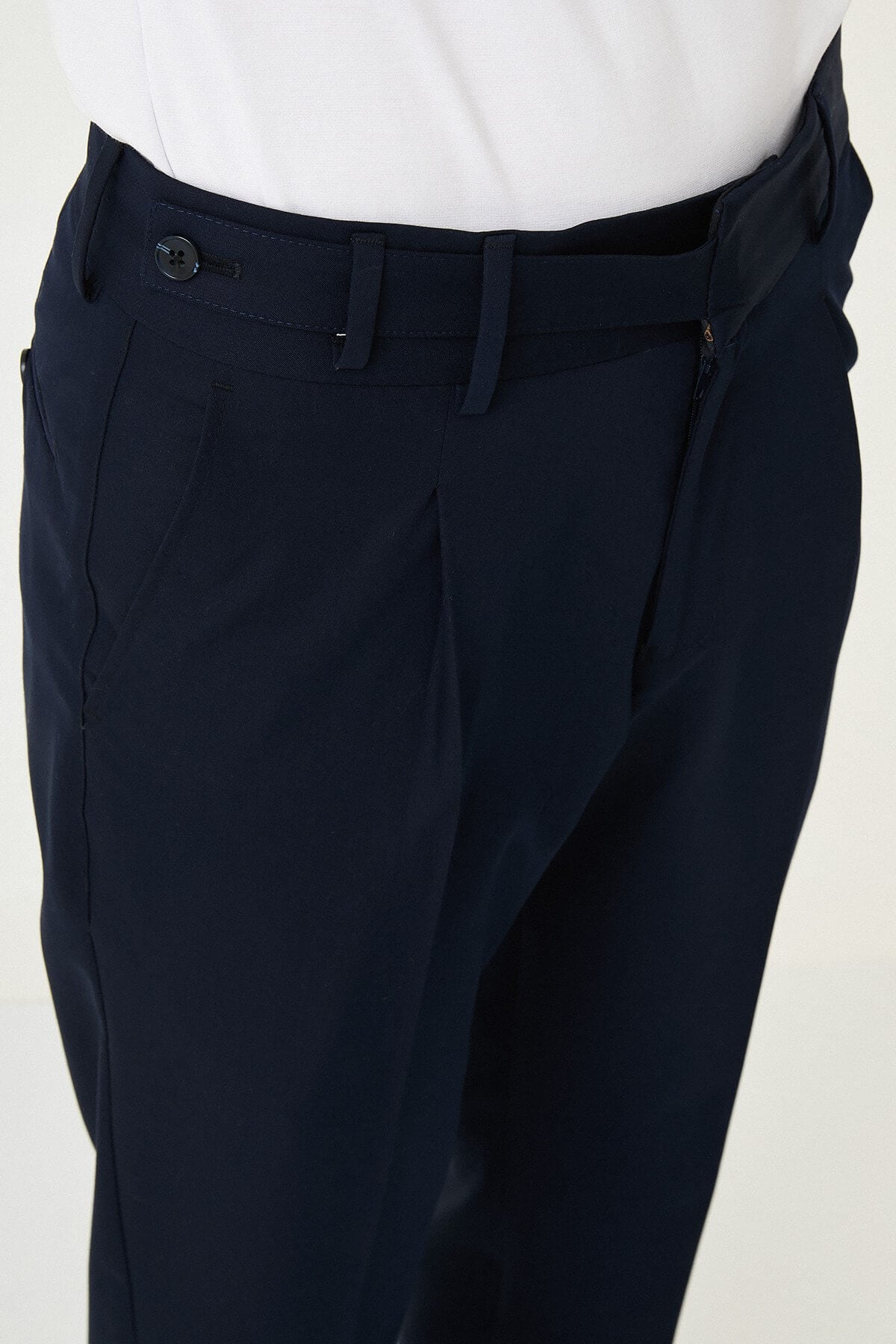 Navy Blue slim-fit straight-leg pleated trousers for men, styled with dark bluw sneakers, ideal for summer business and formal occasions.
