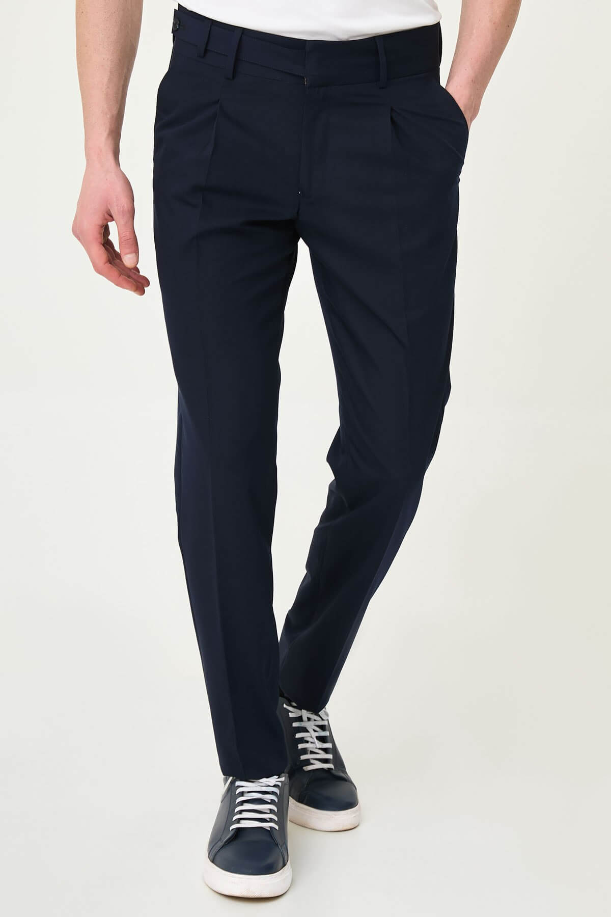 Navy Blue slim-fit straight-leg pleated trousers for men, styled with dark bluw sneakers, ideal for summer business and formal occasions.