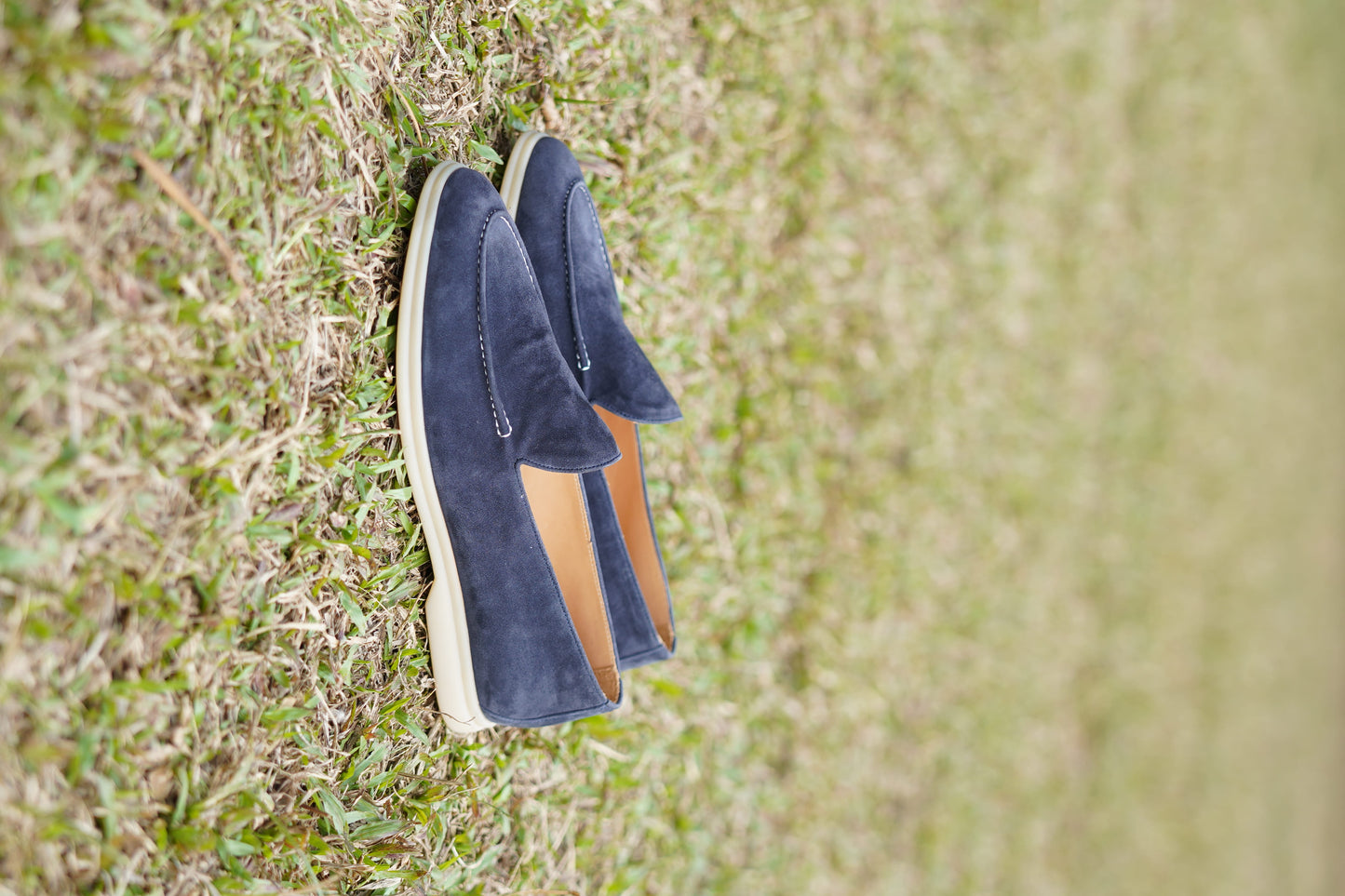 Men’s navy blue suede leather casual slip-on loafers with moccasin stitching and lightweight sole.