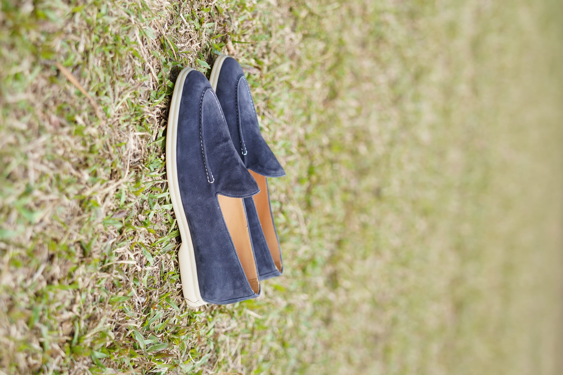 Men’s navy blue suede leather casual slip-on loafers with moccasin stitching and lightweight sole.