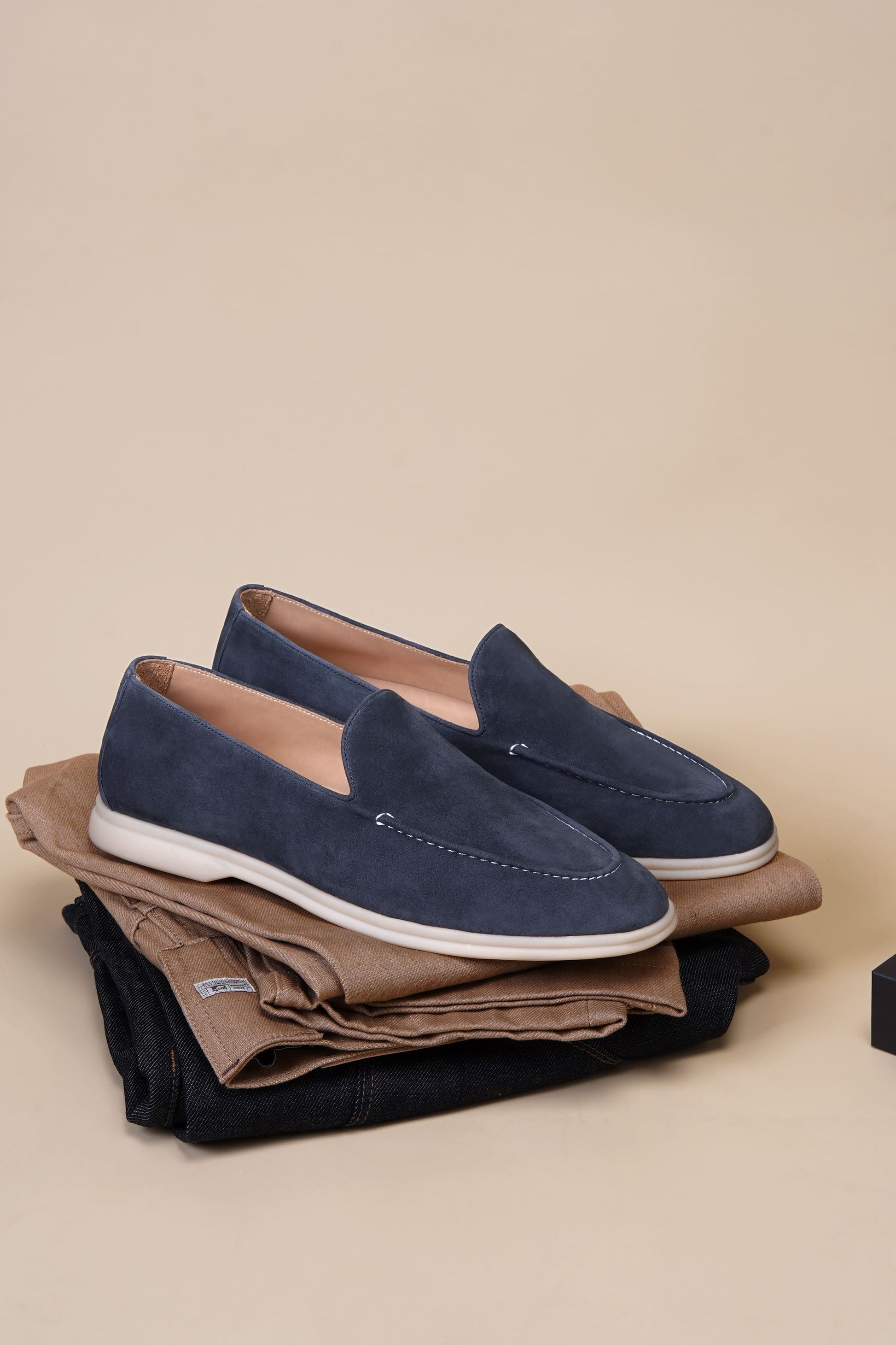 Men’s navy blue suede leather casual slip-on loafers with moccasin stitching and lightweight sole.