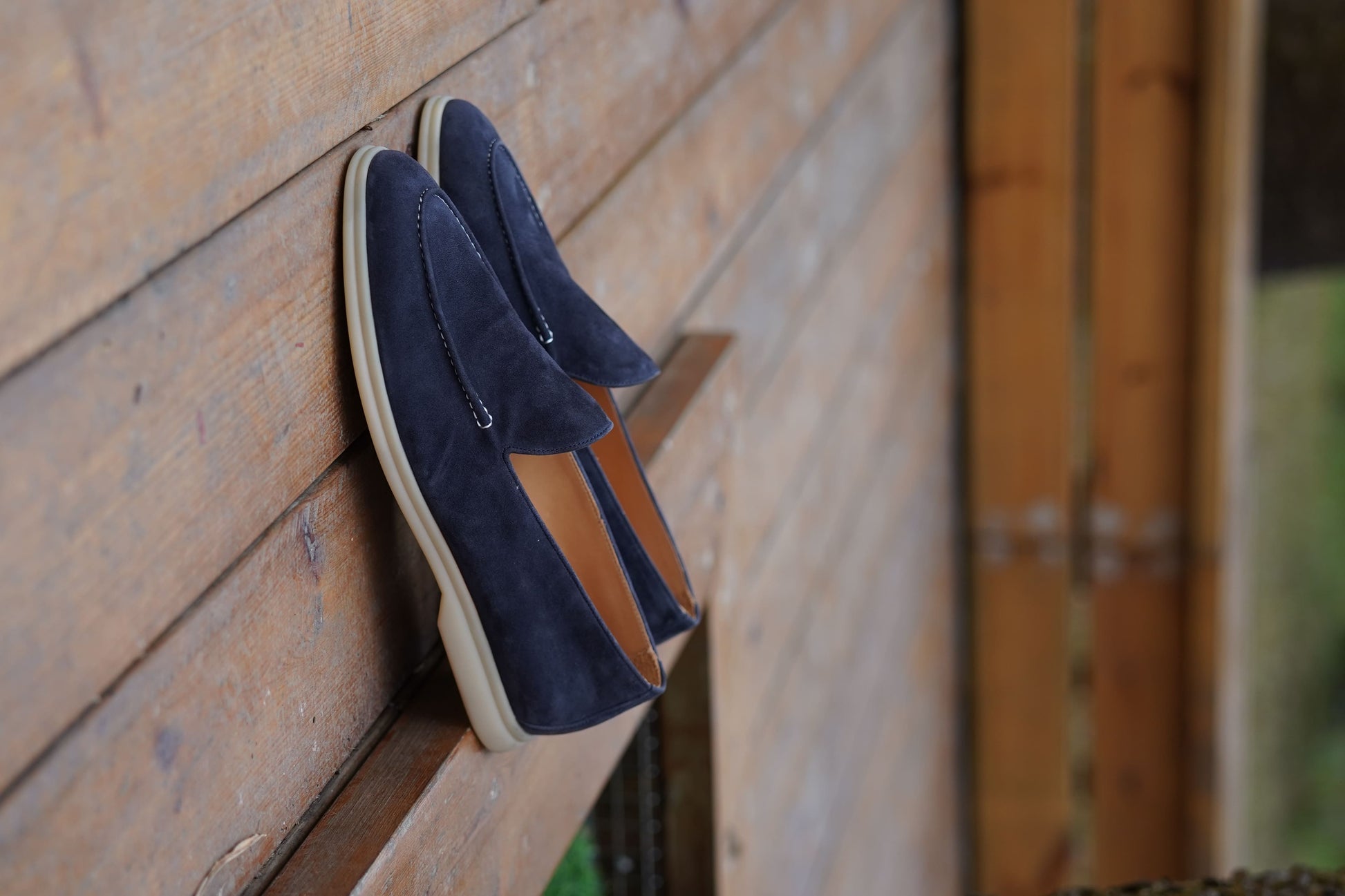 Men’s navy blue suede leather casual slip-on loafers with moccasin stitching and lightweight sole.