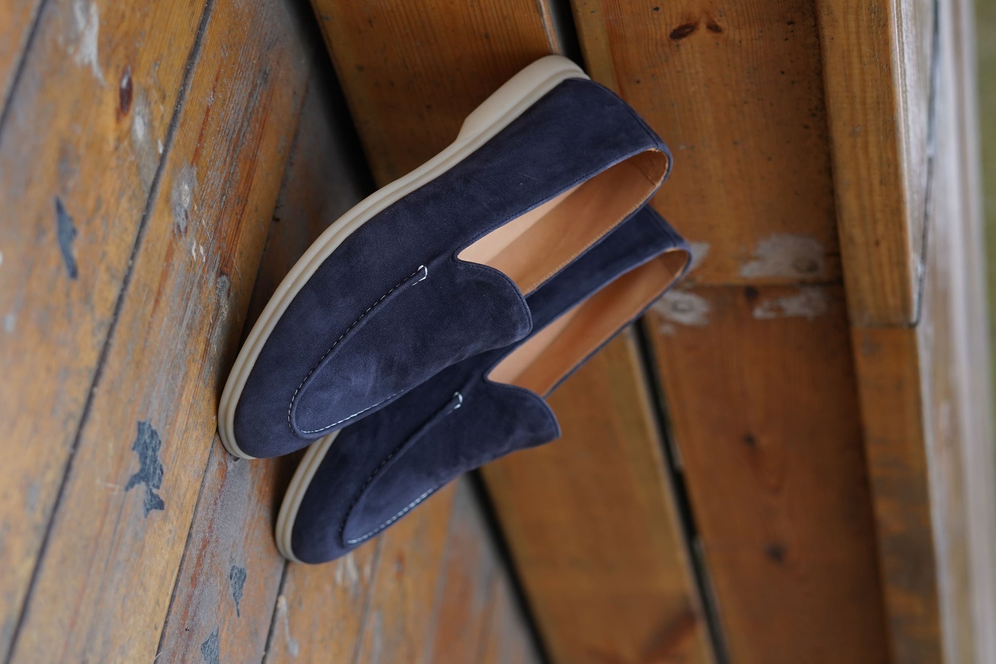Men’s navy blue suede leather casual slip-on loafers with moccasin stitching and lightweight sole.