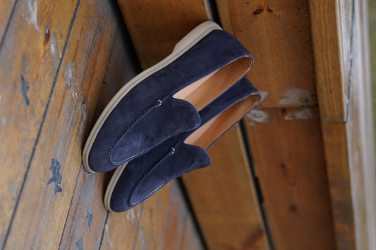 Men’s navy blue suede leather casual slip-on loafers with moccasin stitching and lightweight sole.