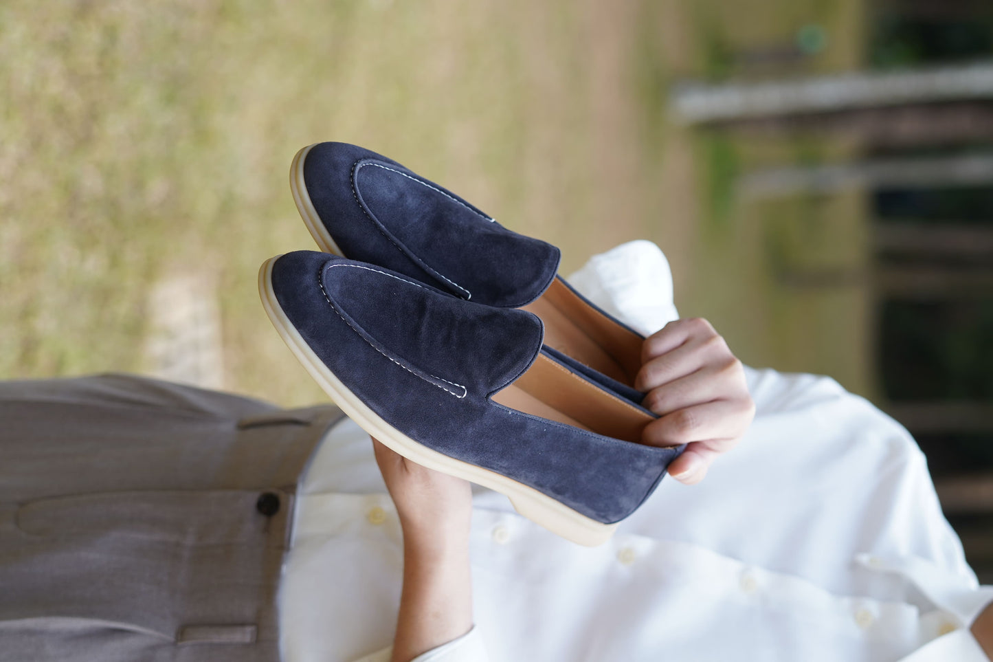 Men’s navy blue suede leather casual slip-on loafers with moccasin stitching and lightweight sole.