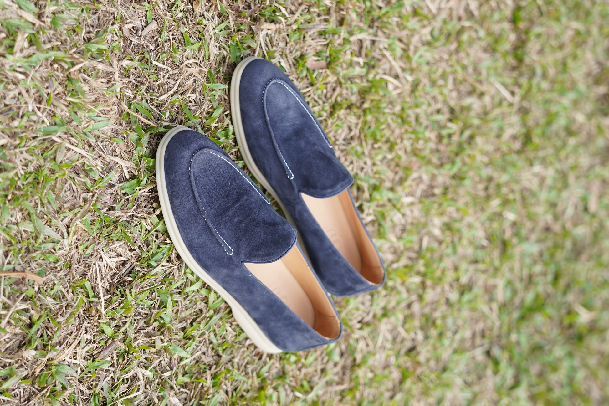 Men’s navy blue suede leather casual slip-on loafers with moccasin stitching and lightweight sole.