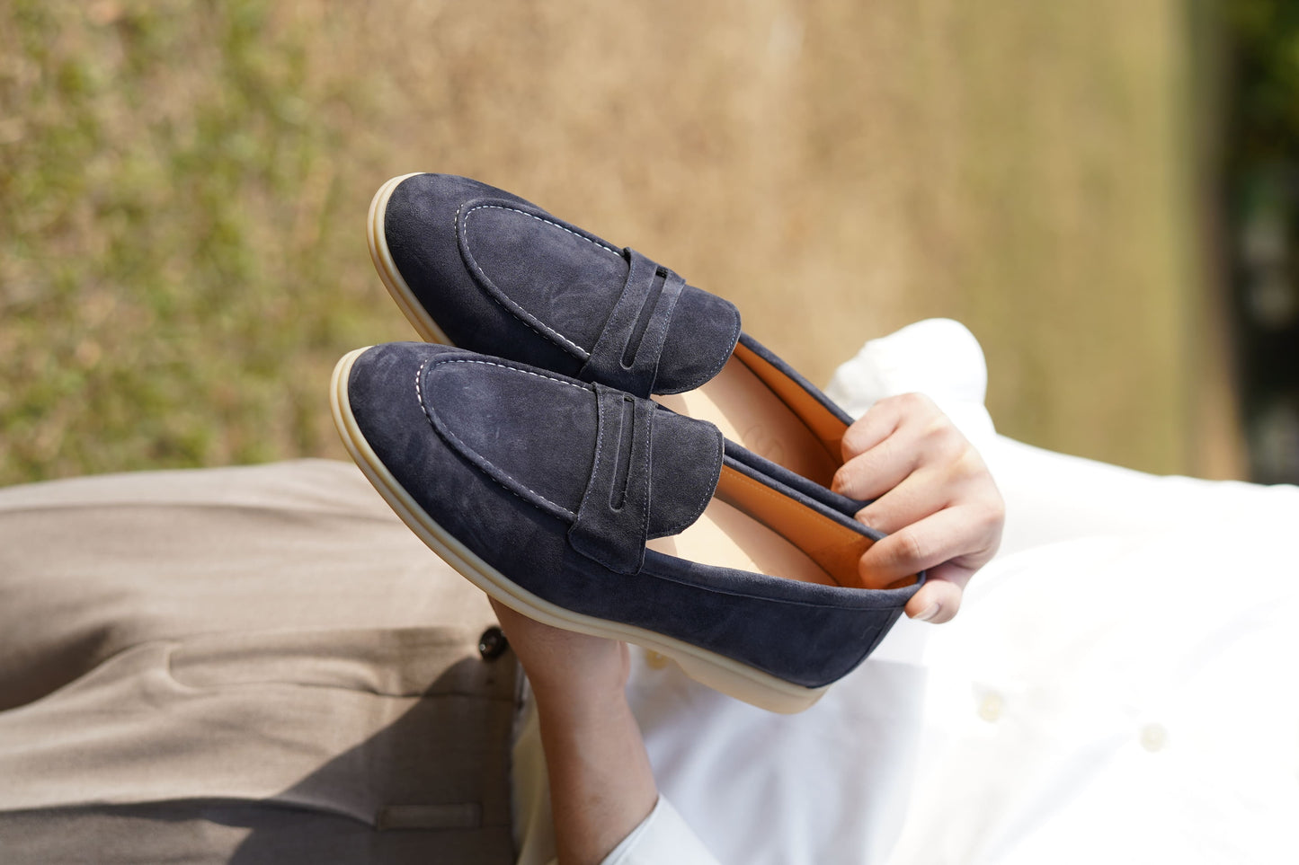 Men’s navy blue suede leather penny loafers with classic vamp strap and lightweight sole.