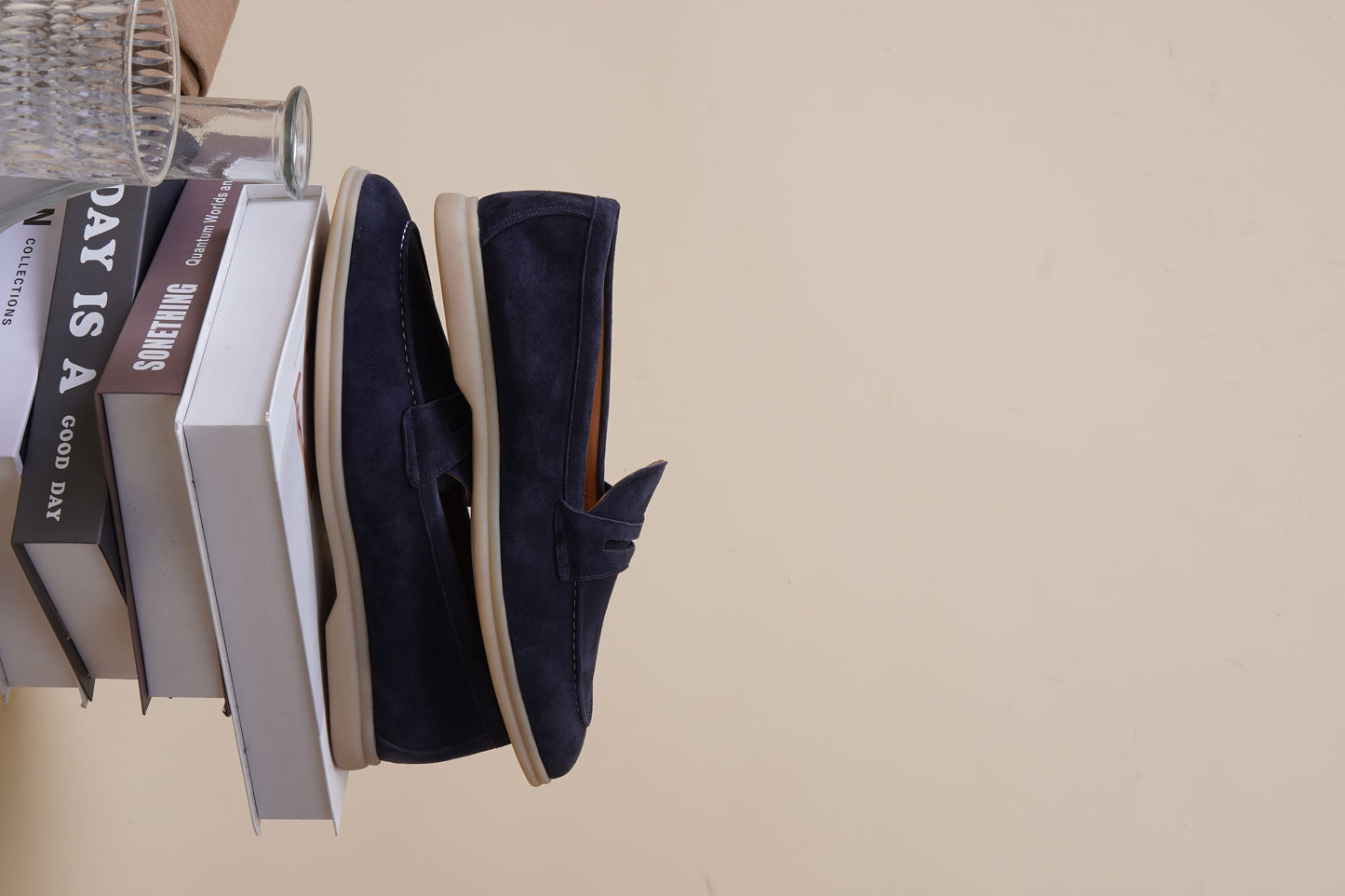 Men’s navy blue suede leather penny loafers with classic vamp strap and lightweight sole.