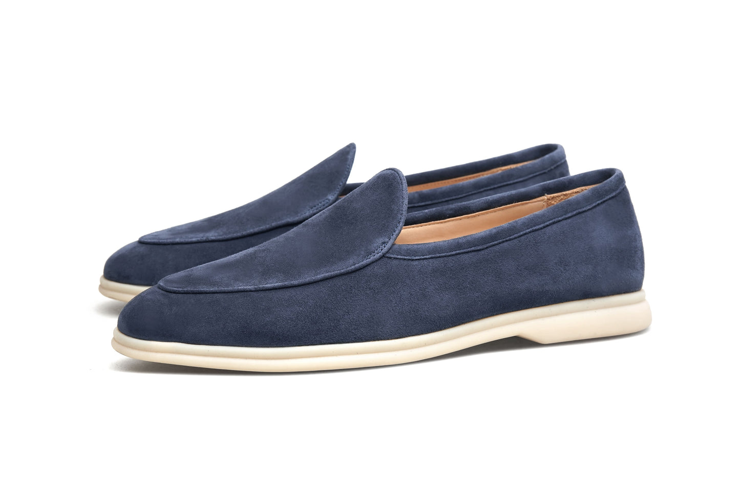 Men’s navy blue suede slip-on loafers featuring a minimalist design and cream sole, styled for elegant summer smart-casual outfits.