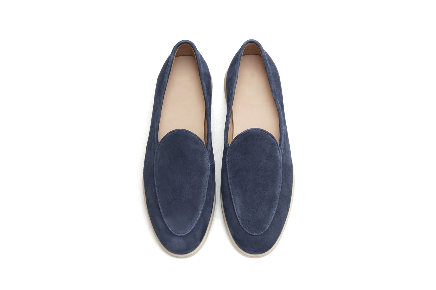 Men’s navy blue suede slip-on loafers featuring a minimalist design and cream sole, styled for elegant summer smart-casual outfits.