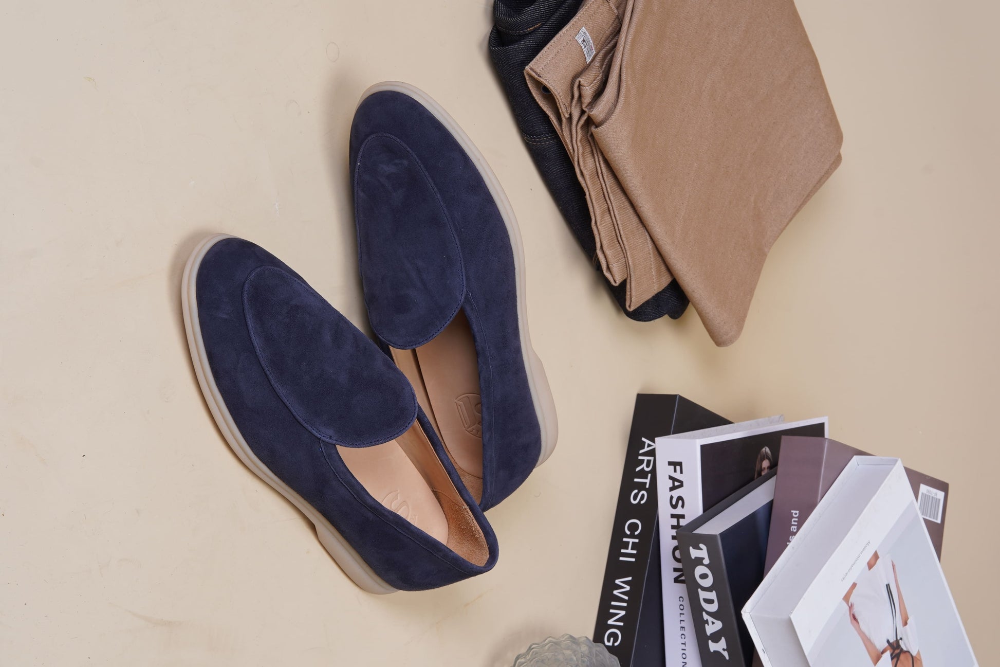 Men’s navy blue suede slip-on loafers featuring a minimalist design and cream sole, styled for elegant summer smart-casual outfits.