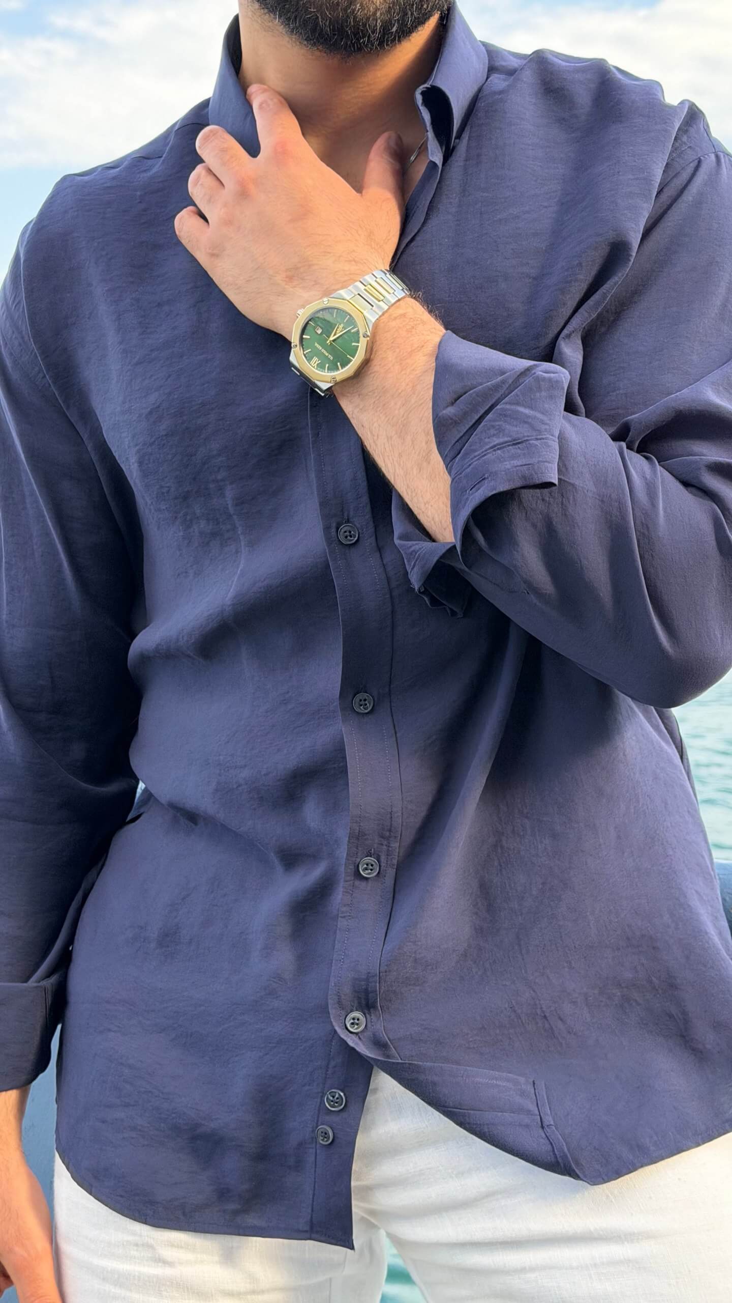 Casual summer look: navy blue oversize shirt with rolled sleeves and white trousers