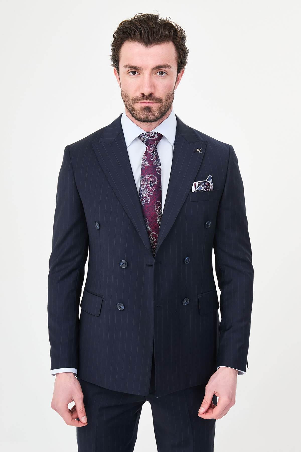 Hollomen Navy Blue Pinstripe Double-Breasted Slim Fit Premium Wool Suit on a male model, styled with a burgundy patterned tie and matching pocket square.