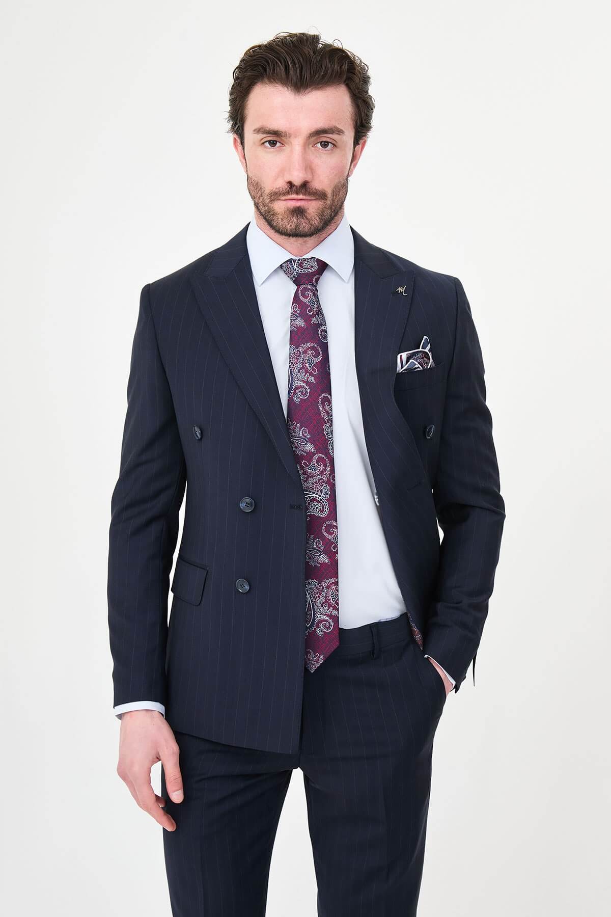 Hollomen Navy Blue Pinstripe Double-Breasted Slim Fit Premium Wool Suit on a male model, styled with a burgundy patterned tie and matching pocket square.