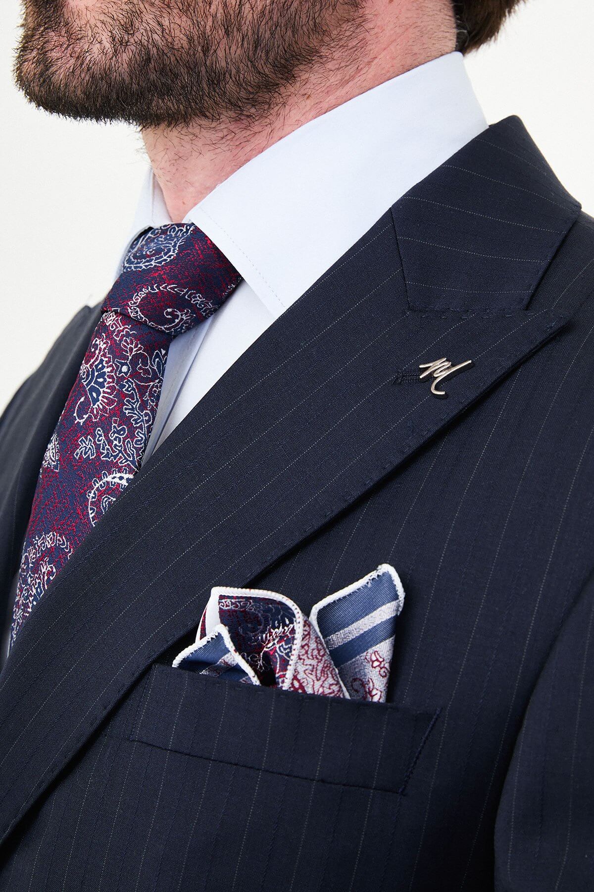 Hollomen Navy Blue Pinstripe Double-Breasted Slim Fit Premium Wool Suit on a male model, styled with a burgundy patterned tie and matching pocket square.