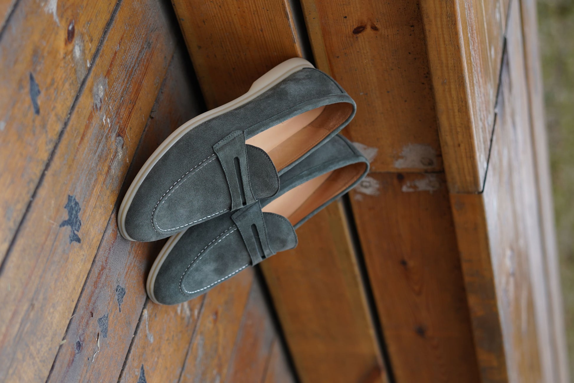 Men’s pale cyan mist suede leather penny loafers with classic strap detail and lightweight cream sole.