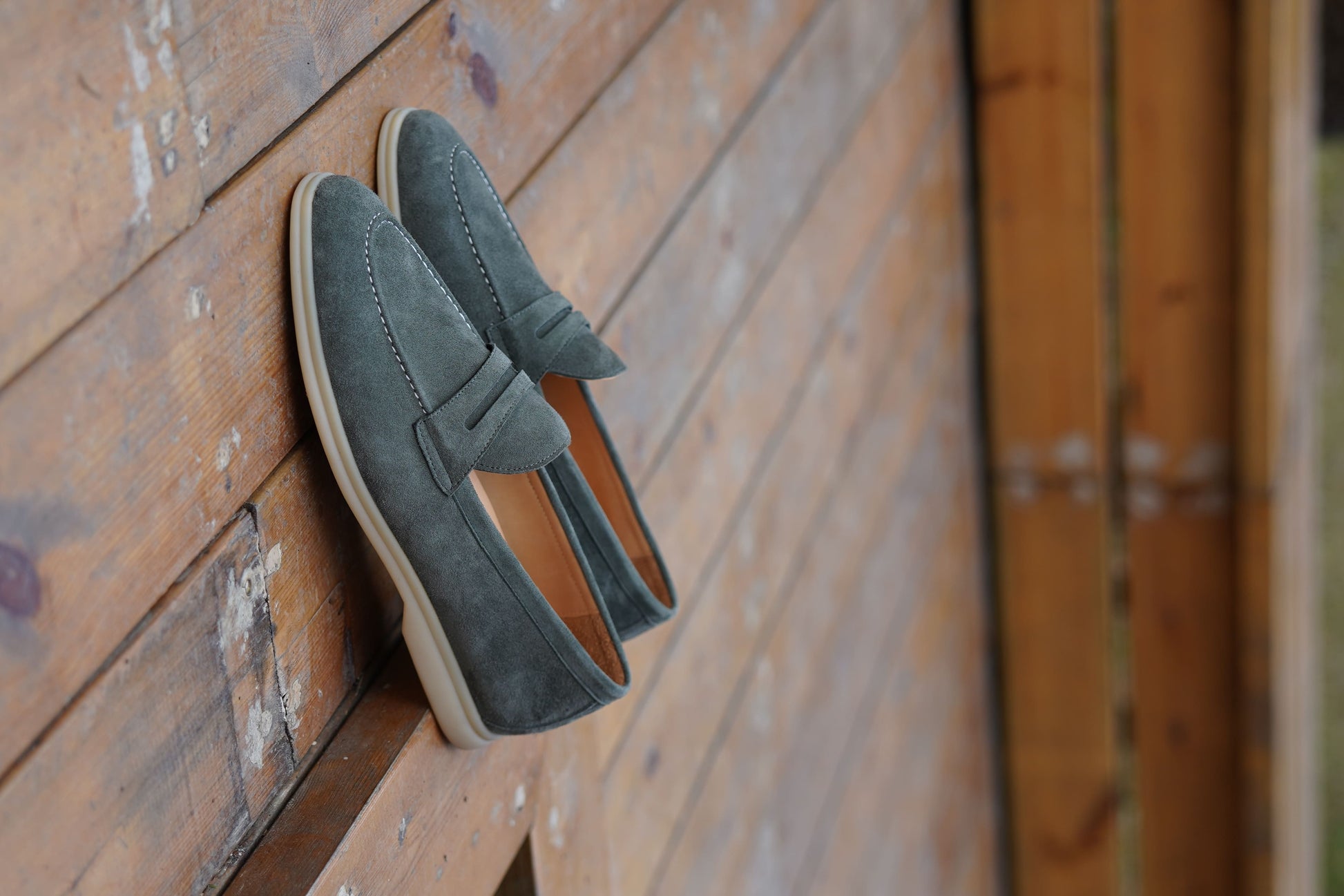 Men’s pale cyan mist suede leather penny loafers with classic strap detail and lightweight cream sole.